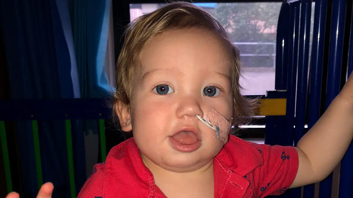 CATERS NEWS (PICTURED Ralphie after his surgery  ) A baby was just 'minutes from death' after swallowing a button battery. One-year-old Ralphie, from Watford, Herts, is lucky to be alive after a small round battery began burning his insides. Initially, Hollie Phillips, 27, assumed Ralphie had eaten cereal off the floor but within a matter of minutes - he was crying and projectile vomiting. A metal detector at the hospital came back clear but Hollie, the charity event organiser, knew something was wrong with her boy. SEE CATERS COPY
