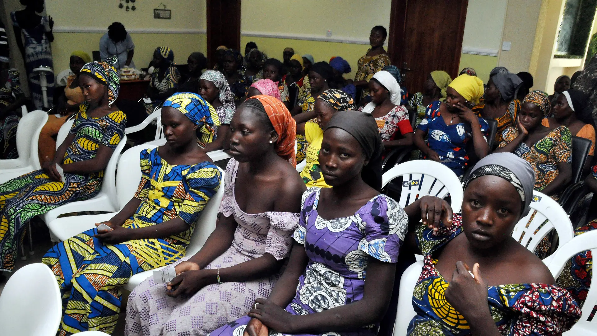 FILE - In this Sunday, May 7, 2017 file photo, Chibok school girls freed from Boko Haram captivity are photographed in Abuja, Nigeria. Seven years after Boko Haram extremists abducted more than 270 schoolgirls in northeast Nigeria, two of the more than 100 still being held by the rebels returned this month, renewing the hope of parents who have all but given up on the long wait for the return of their children. Some of the affected parents said they remain hopeful that they will reunite with their children in Borno State, where the Boko Haram insurgency has lasted for more than a decade. (AP Photo/ Olamikan Gbemiga, File)