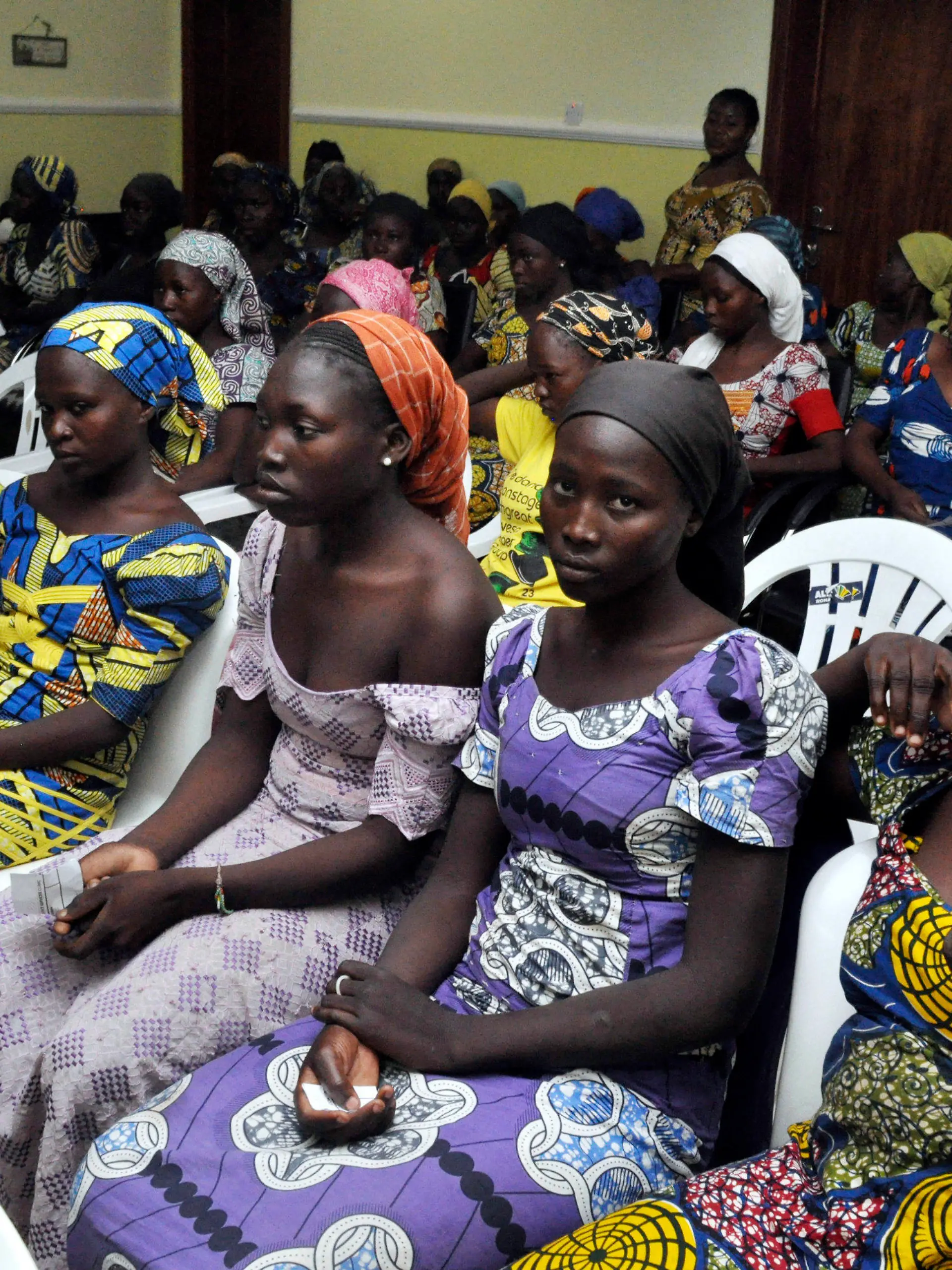 FILE - In this Sunday, May 7, 2017 file photo, Chibok school girls freed from Boko Haram captivity are photographed in Abuja, Nigeria. Seven years after Boko Haram extremists abducted more than 270 schoolgirls in northeast Nigeria, two of the more than 100 still being held by the rebels returned this month, renewing the hope of parents who have all but given up on the long wait for the return of their children. Some of the affected parents said they remain hopeful that they will reunite with their children in Borno State, where the Boko Haram insurgency has lasted for more than a decade. (AP Photo/ Olamikan Gbemiga, File)