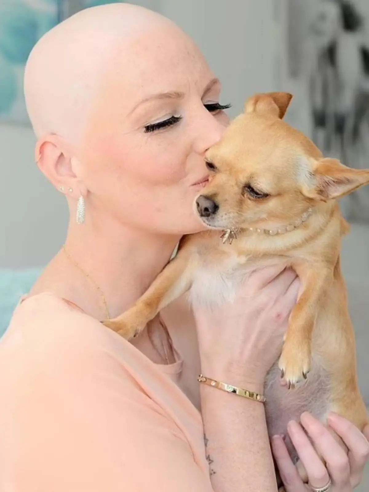Eine krebskranke Frau küsst ihren Chihuahua Lola.