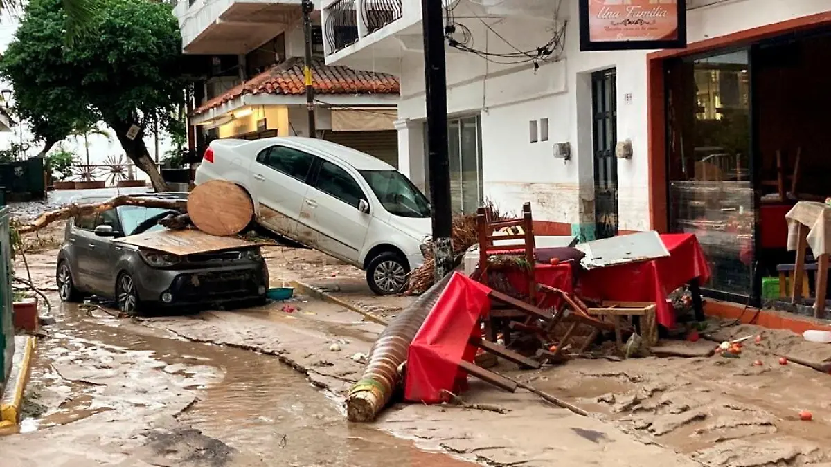 Damaged cars are pictured on a flooded street after Hurricane Nora pounds Mexico's coast with heavy rains and strong winds in Puerto Vallarta, in Jalisco state, Mexico August 29, 2021. REUTERS/Alfonso Lepe NO RESALES. NO ARCHIVES