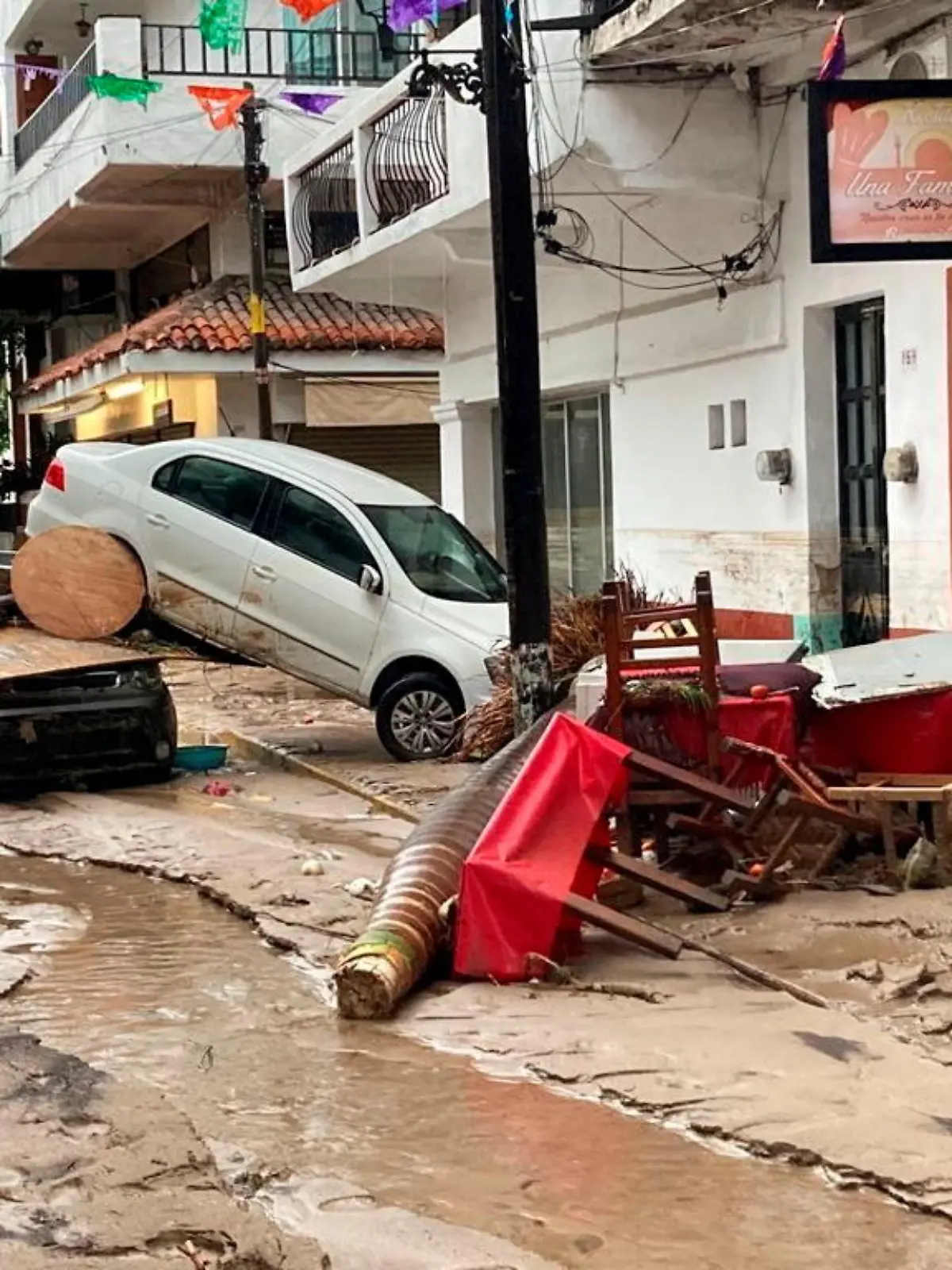 Damaged cars are pictured on a flooded street after Hurricane Nora pounds Mexico's coast with heavy rains and strong winds in Puerto Vallarta, in Jalisco state, Mexico August 29, 2021. REUTERS/Alfonso Lepe NO RESALES. NO ARCHIVES