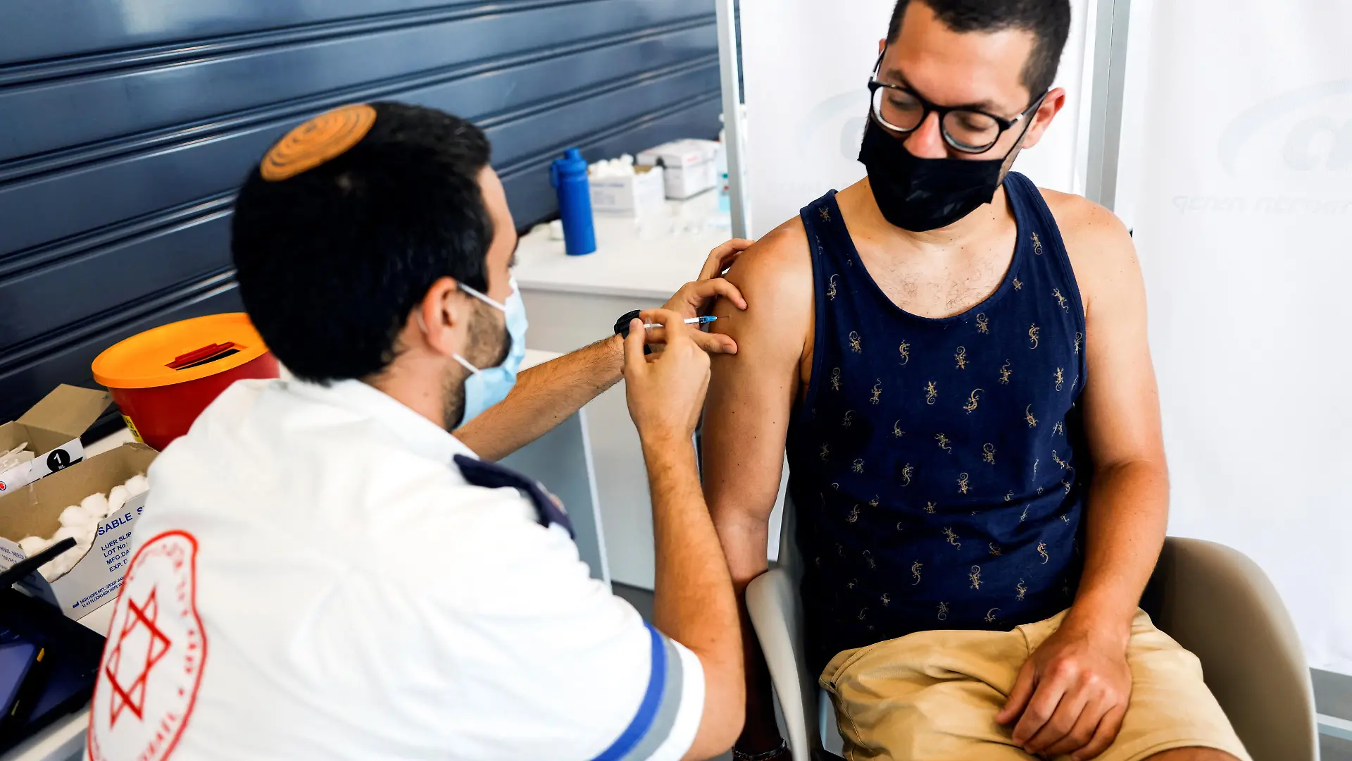 An Israeli man receives a third shot of coronavirus disease (COVID-19) vaccine in Tel Aviv, Israel August 30, 2021. REUTERS/Amir Cohen