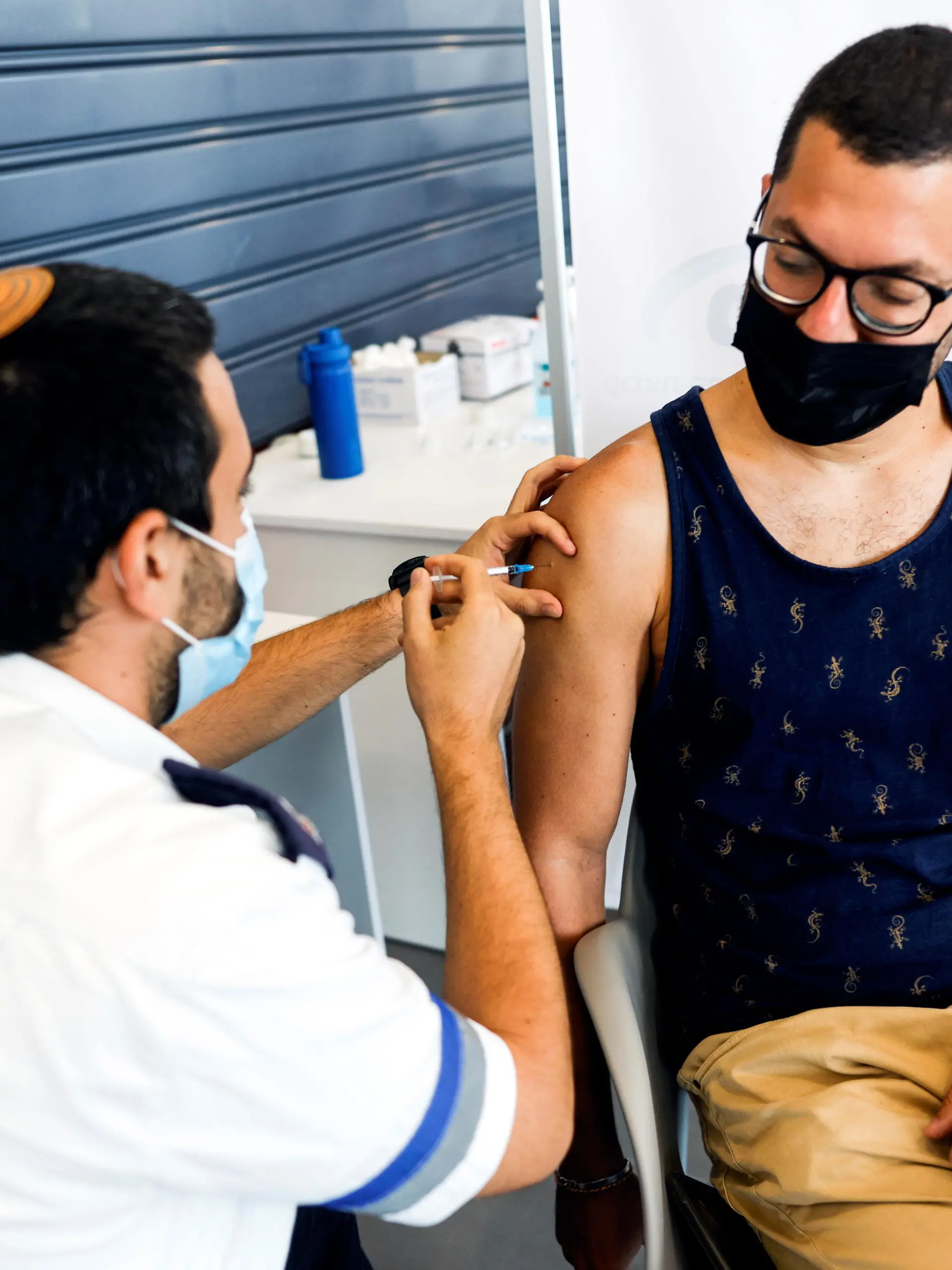 An Israeli man receives a third shot of coronavirus disease (COVID-19) vaccine in Tel Aviv, Israel August 30, 2021. REUTERS/Amir Cohen