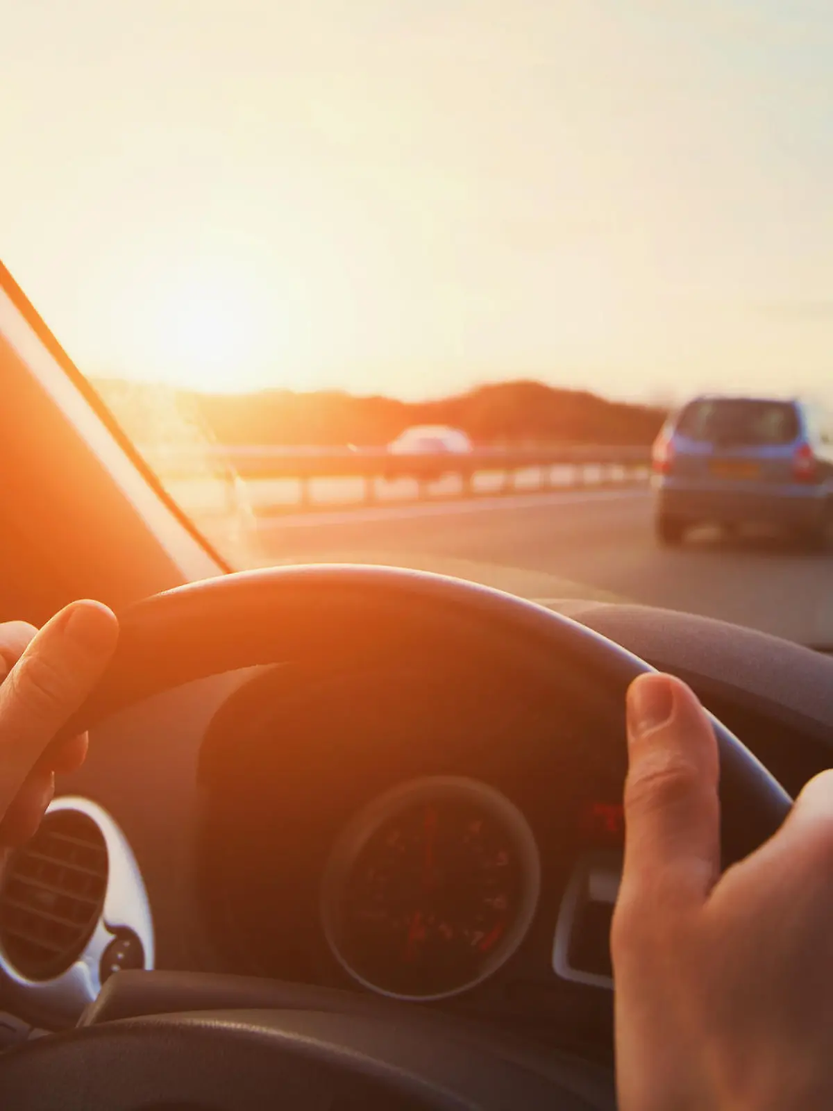 hands of car driver on steering wheel, road trip, driving on highway road
