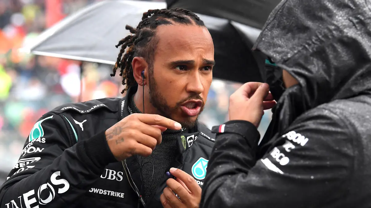 Mercedes driver Lewis Hamilton of Britain, left, speaks with a member of his crew prior to the Formula One Grand Prix at the Spa-Francorchamps racetrack in Spa, Belgium, Sunday, Aug. 29, 2021. (John Thys, Pool Photo via AP)