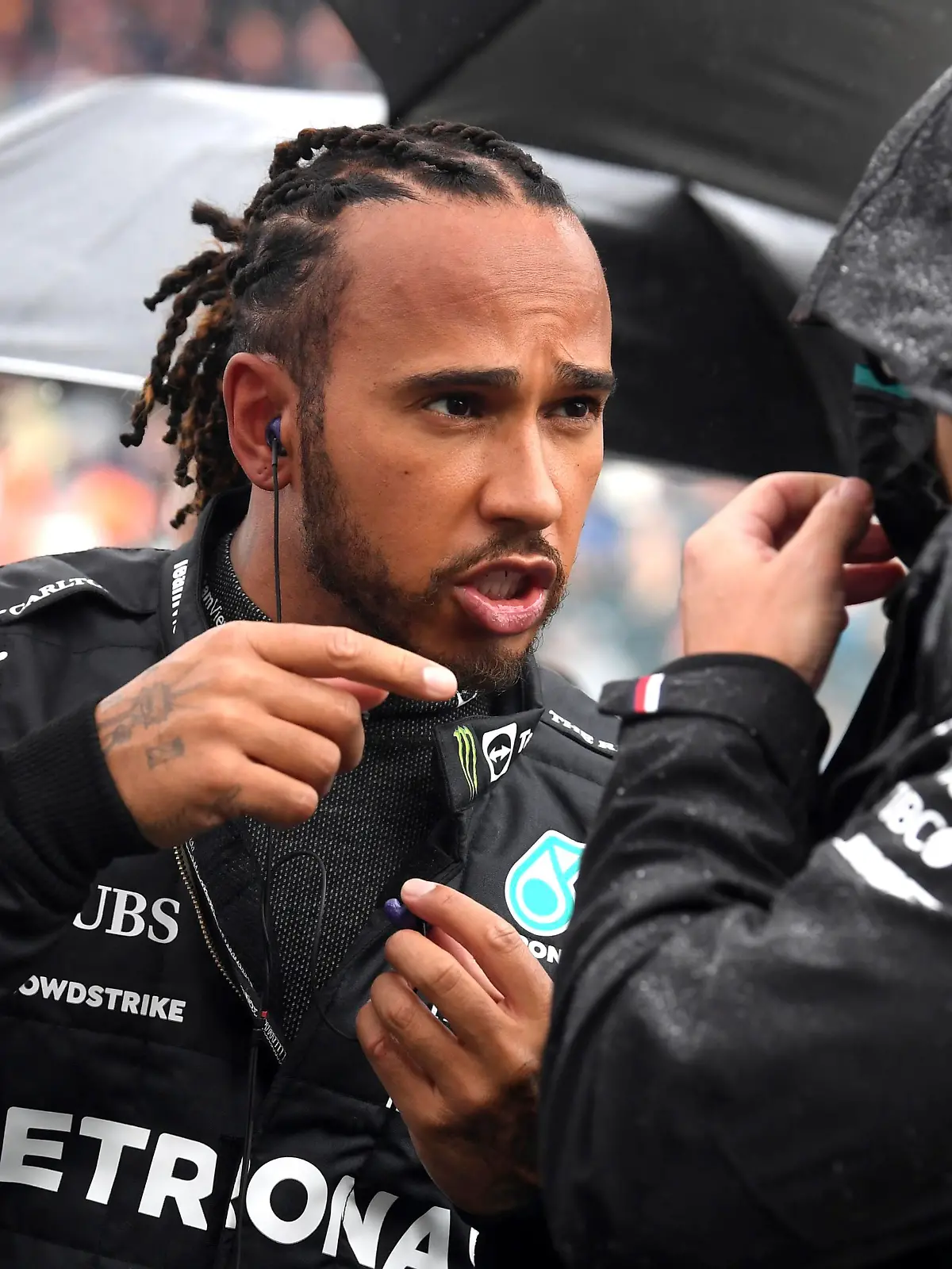 Mercedes driver Lewis Hamilton of Britain, left, speaks with a member of his crew prior to the Formula One Grand Prix at the Spa-Francorchamps racetrack in Spa, Belgium, Sunday, Aug. 29, 2021. (John Thys, Pool Photo via AP)