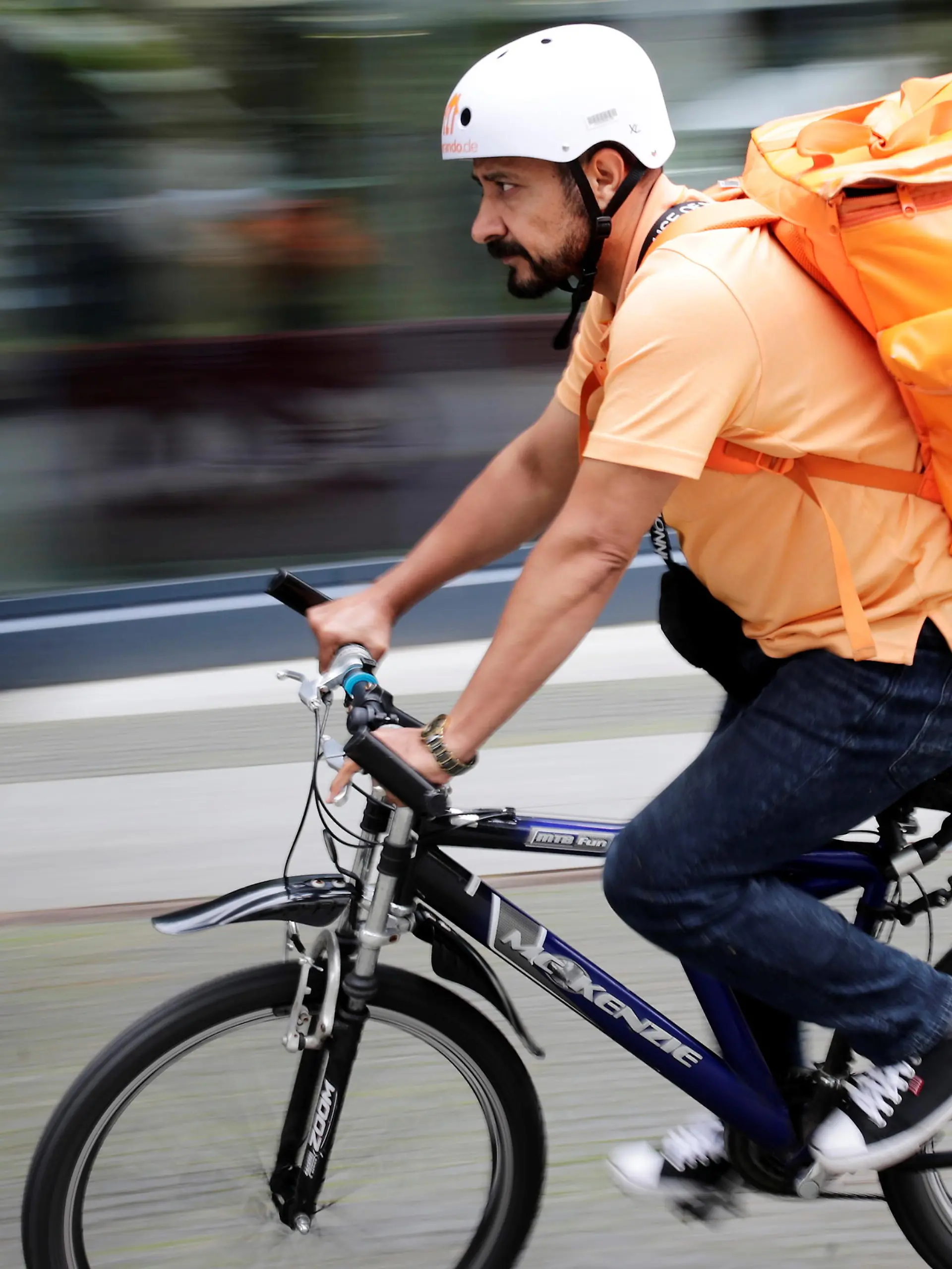 Former Afghan Communication Minister Sayed Sadaat rides a bicycle for his food delivery service job with Lieferando in Leipzig, Germany, August 26, 2021. REUTERS/Hannibal Hanschke