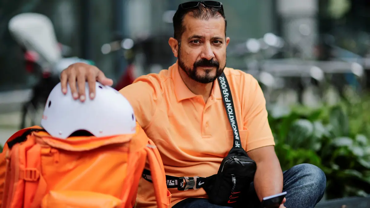 Former Afghan Communication Minister Sayed Sadaat sits with his gear as he works for the food delivery service Lieferando in Leipzig, Germany, August 26, 2021. REUTERS/Hannibal Hanschke