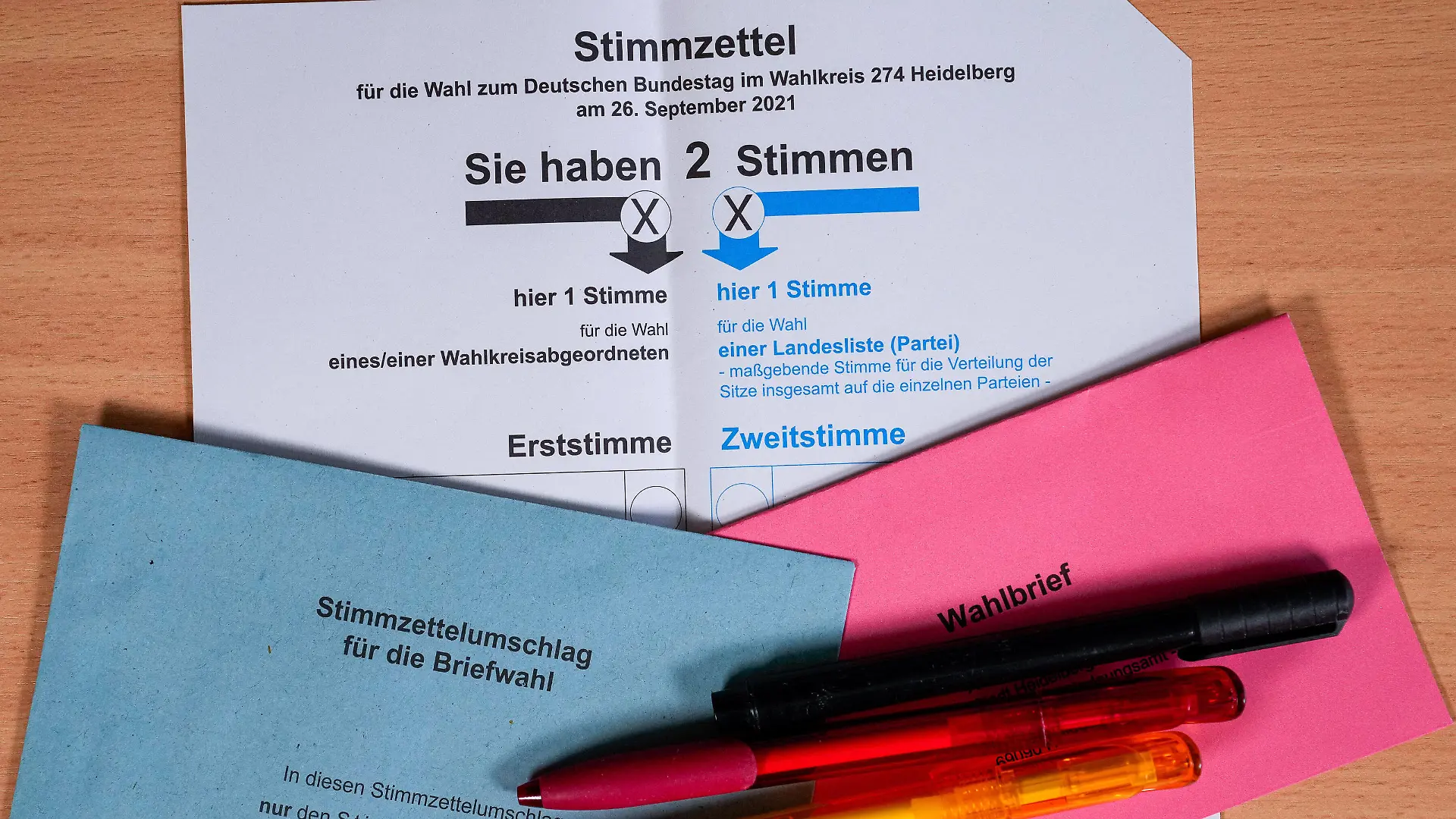 Der offzielle und amtliche Stimmzettel zur Bundestagswahl am 26. September 2021 der Stadt Heidelberg, Das Foto zeigt den Wahlzettel sowie einen roten und einen blauen Stimmzettelumschlag sowie Kugelschreiber in den Farben Schwarz, Rot und Gold, Symbolfoto, Symbolbild, Symbol, 25.08.2021, Heidelberg Deutschland, Politik, Bundestagswahl 2021 in Deutschland, Briefwahl *** The official ballot paper for the Bundestag election on 26 September 2021 of the city of Heidelberg, The photo shows the ballot paper as well as a red and a blue ballot paper envelope as well as ballpoint pens in the colors black, red and gold, symbol photo, symbol picture, symbol, 25 08 2021, Heidelberg Germany , politics, Bundestag election 2021 in Germany, postal vote xozx