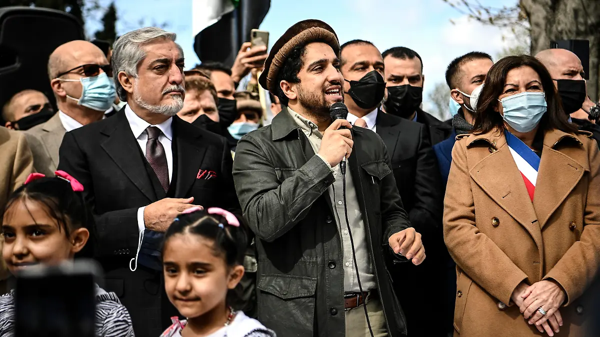 Ahmad Massoud, son of late Afghan commander Ahmad Shah Massoud, center, speaks supporters as he is flanked by Chairman of Afghanistan's High Council for National Reconciliation Abdullah Abdullah, left, and Paris Mayor Anne Hidalgo on the sidelines of a commemoration to honor late Afghan anti-Taliban commander Massoud in an alley along the Champs Elysees Avenue in Paris, Saturday, March 27, 2021. (Christophe Archambault/Pool Photo via AP)