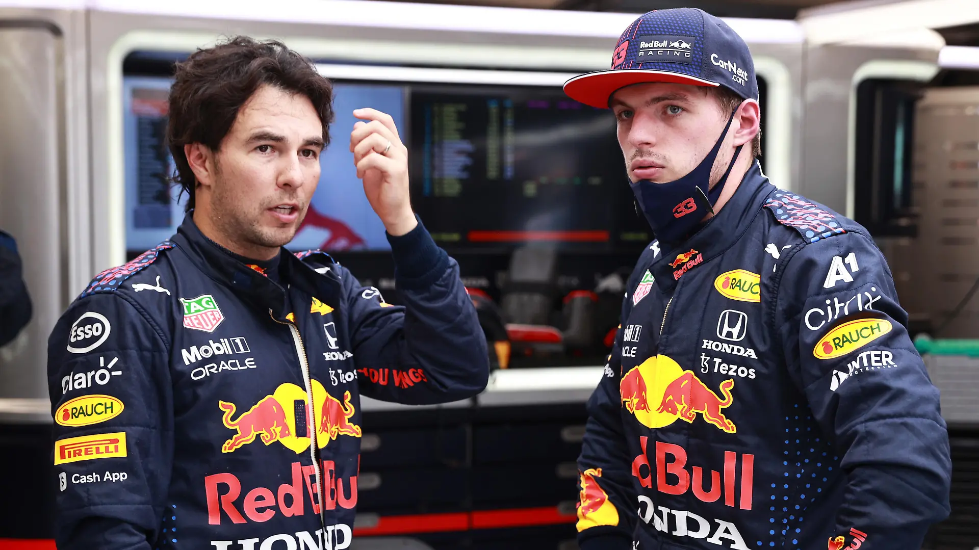 BUDAPEST, HUNGARY - AUGUST 01: Max Verstappen of Netherlands and Red Bull Racing and Sergio Perez of Mexico and Red Bull Racing talk in the garage during the red flag delay during the F1 Grand Prix of Hungary at Hungaroring on August 01, 2021 in Budapest, Hungary. (Photo by Mark Thompson/Getty Images)