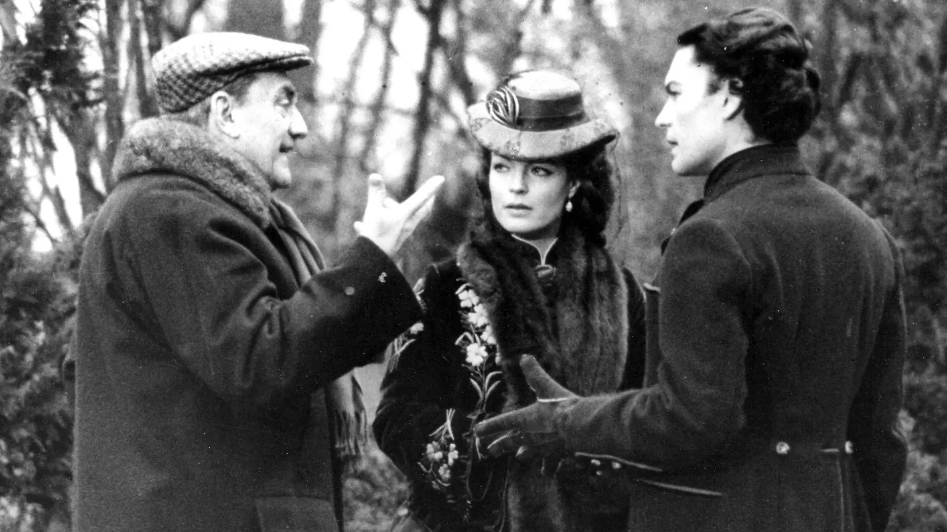 FILE -Italian movie director Luchino Visconti, left, gives last instructions to actor Helmut Berger and actress Romy Schneider before filming a scene of 'Ludwig' at a location near Munich, Germany, April 15, 1972. Austrian-born actor Helmut Berger, a European movie star in the 1960s and 1970s who rose to prominence with roles in films by Italian director Luchino Visconti, has died. He was 78. (AP Photo/Str, File)