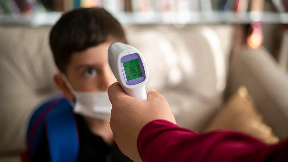 Mother taking temperature of kids