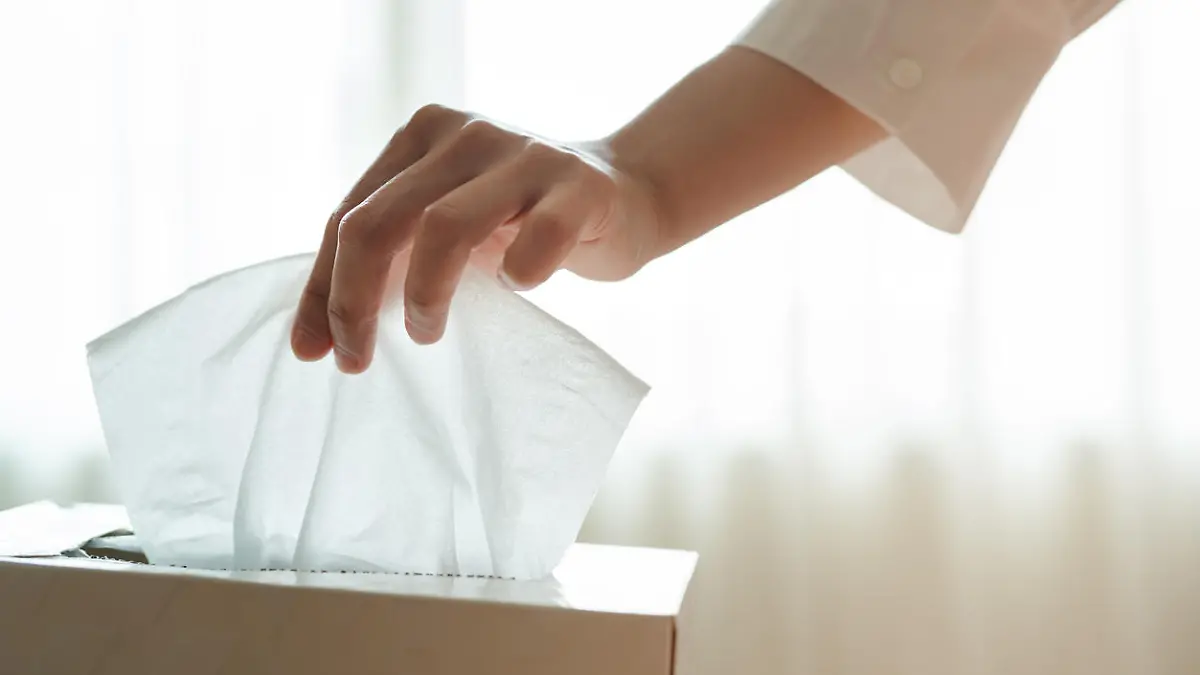 women hand picking napkin/tissue paper from the tissue box
