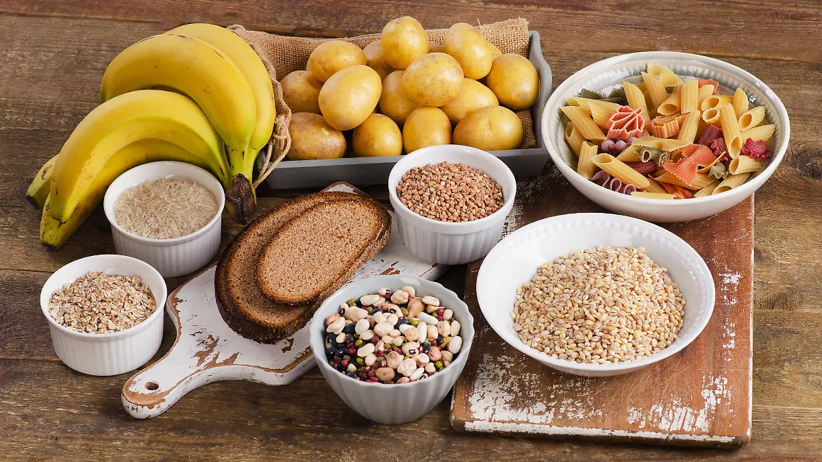 Foods high in carbohydrate on wooden background. Top view