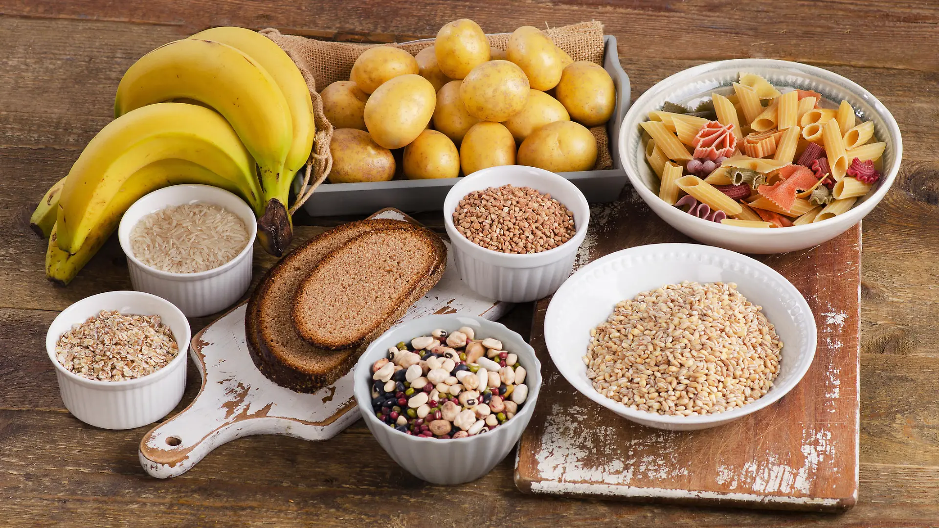 Foods high in carbohydrate on wooden background. Top view