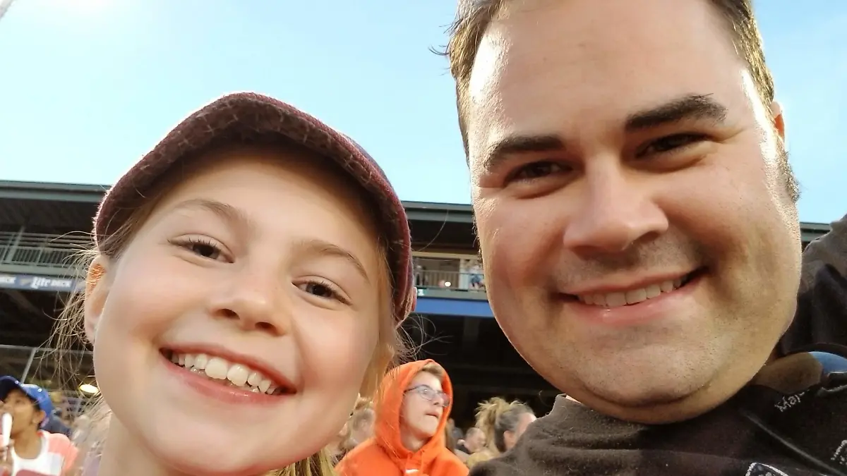 Daughter and dad and sporting event