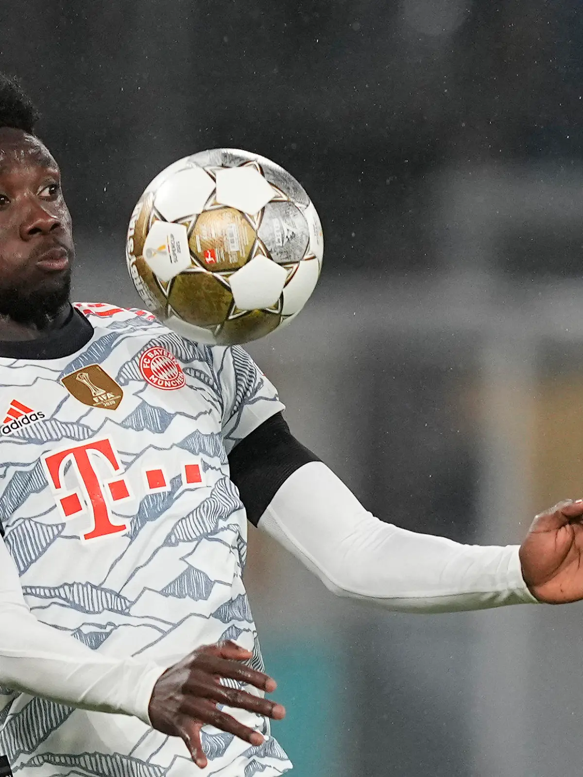 Bayern's Alphonso Davies controls the ball in the air during the German Supercup soccer match between Borussia Dortmund and Bayern Munich in Dortmund, Germany, Tuesday, Aug. 17, 2021. (AP Photo/Martin Meissner)