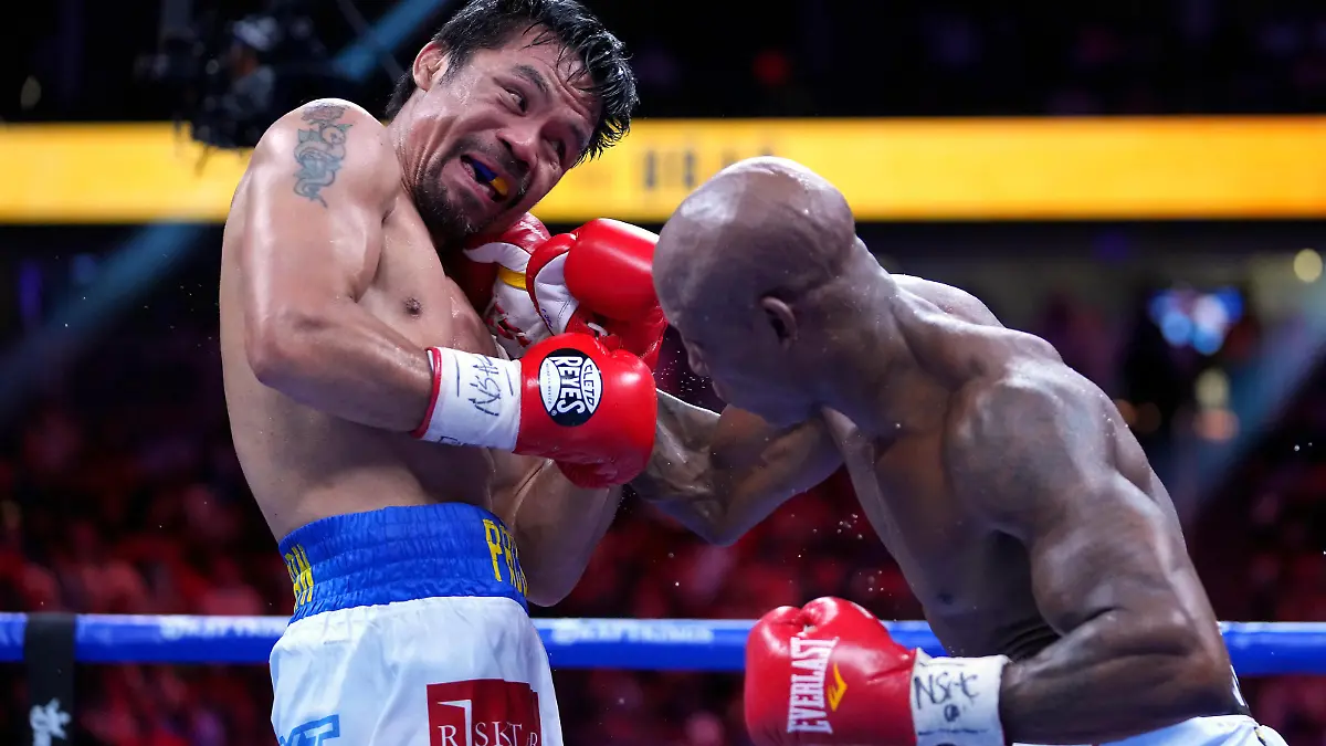 Aug 21, 2021; Las Vegas, Nevada; Manny Pacquiao (left) fights Yordenis Ugas in a world welterweight championship bout at T-Mobile Arena. Mandatory Credit: Stephen R. Sylvanie-USA TODAY Sports