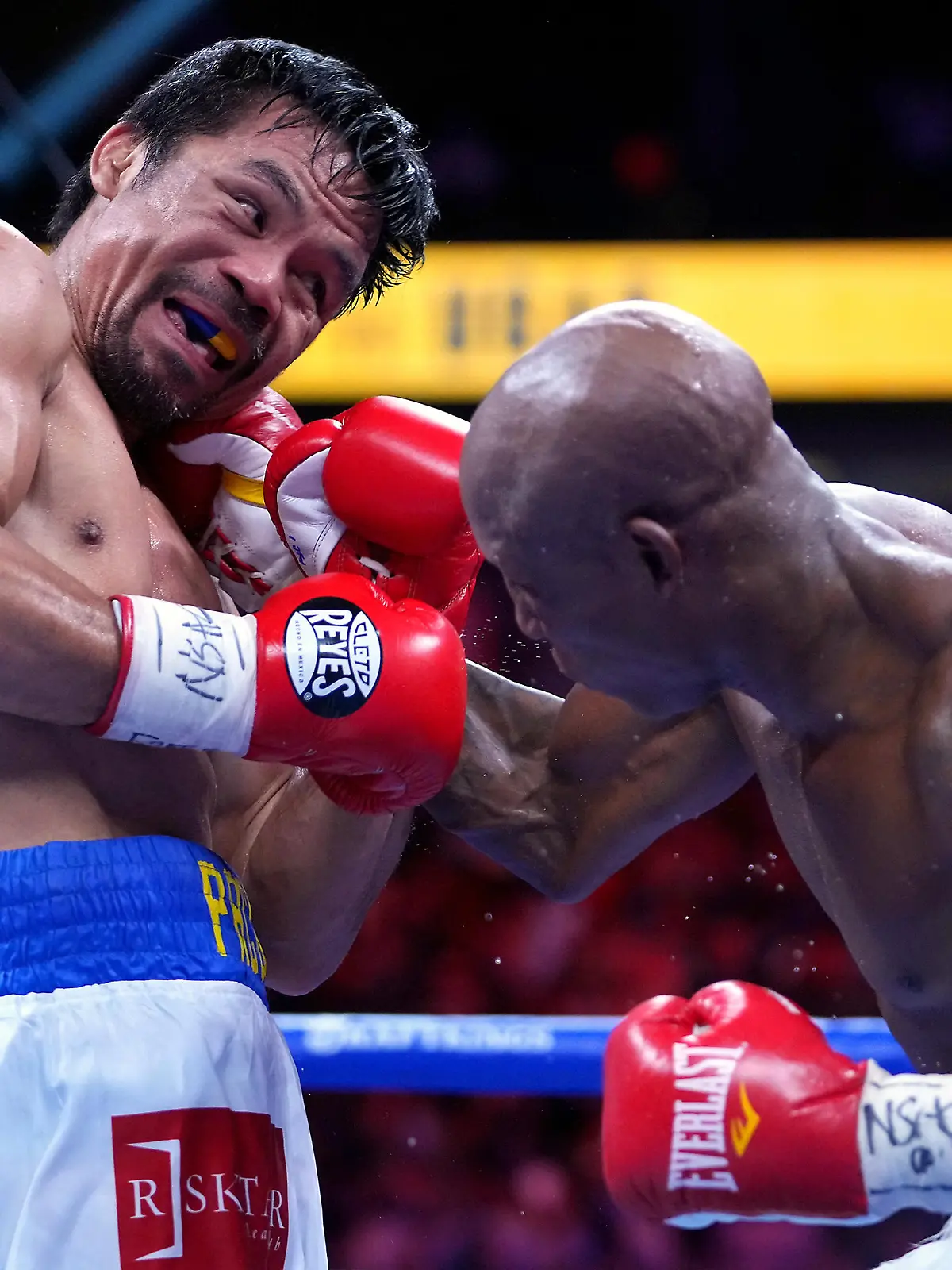 Aug 21, 2021; Las Vegas, Nevada; Manny Pacquiao (left) fights Yordenis Ugas in a world welterweight championship bout at T-Mobile Arena. Mandatory Credit: Stephen R. Sylvanie-USA TODAY Sports