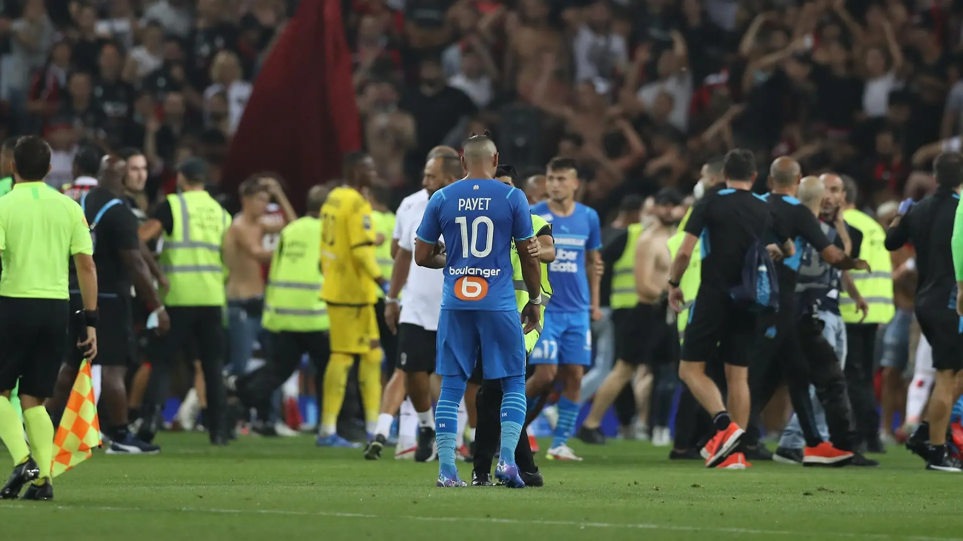 August 22, 2021, Nice, United Kingdom: Nice, France, 22nd August 2021. Fans spill onto the pitch to interrupt the game after the Dimitri Payet of Olympique De Marseille threw an object back into the crown that was intially thrown in his direction during the Lique 1 match at Allianz Riviera Stadium, Nice. Picture credit should read: Jonathan Moscrop / Sportimage Photo via Newscom picture alliance