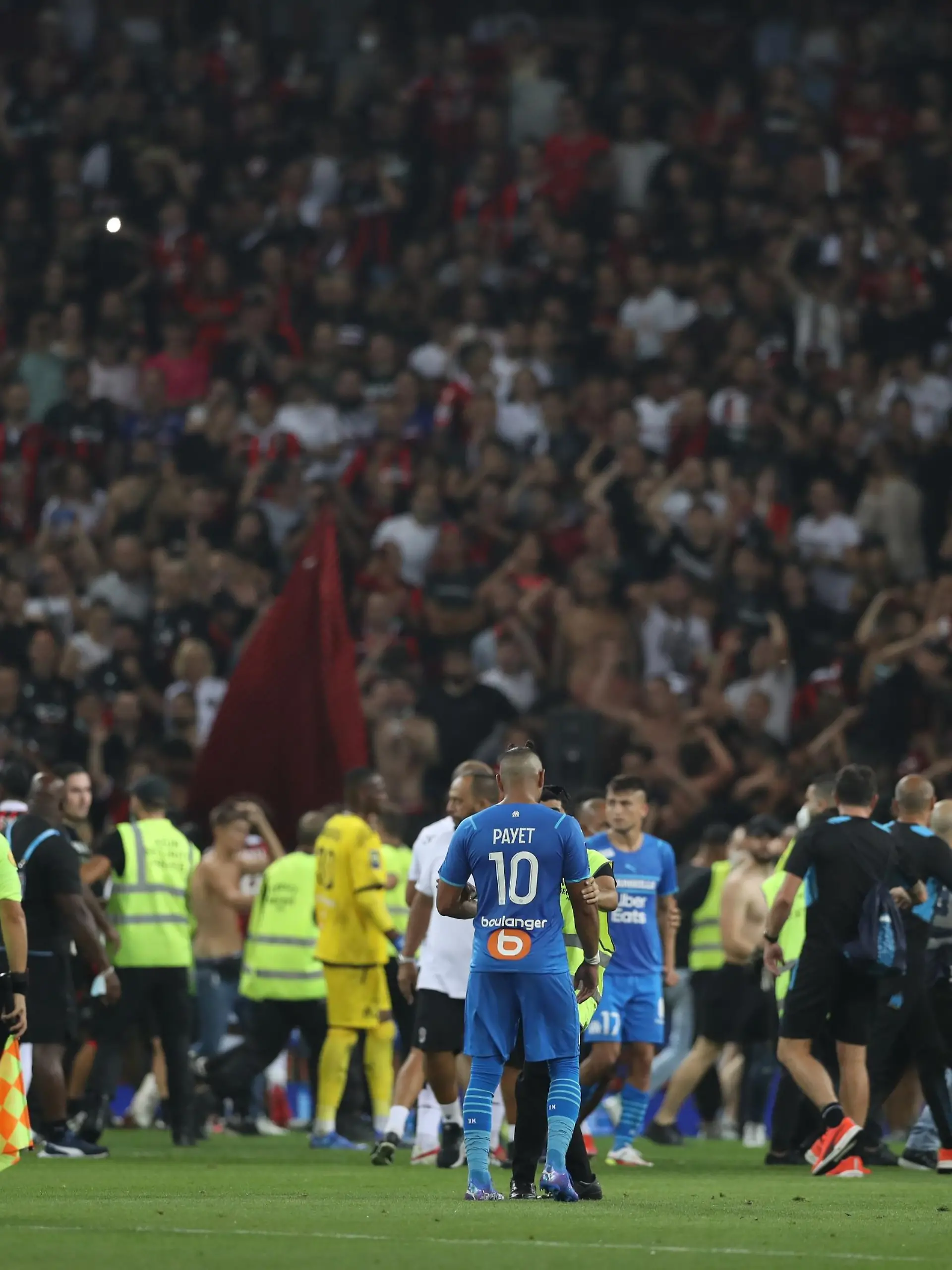 August 22, 2021, Nice, United Kingdom: Nice, France, 22nd August 2021. Fans spill onto the pitch to interrupt the game after the Dimitri Payet of Olympique De Marseille threw an object back into the crown that was intially thrown in his direction during the Lique 1 match at Allianz Riviera Stadium, Nice. Picture credit should read: Jonathan Moscrop / Sportimage Photo via Newscom picture alliance