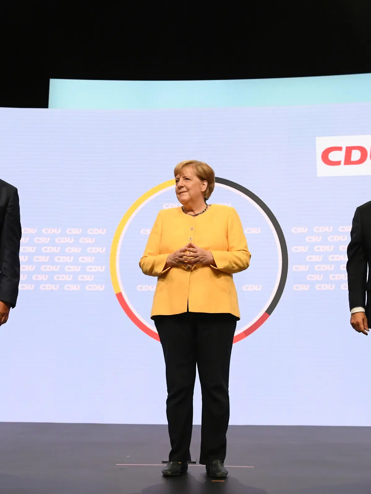 CSU party chief Markus Soeder waves as he stands next to German Chancellor Angela Merkel and Prime Minister of North Rhine-Westphalia and candidate for chancellor of the CDU/CSU Armin Laschet during a CDU/CSU campaign kick off ahead of the federal election at Tempodrom in Berlin, Germany, August 21, 2021.  REUTERS/Annegret Hilse