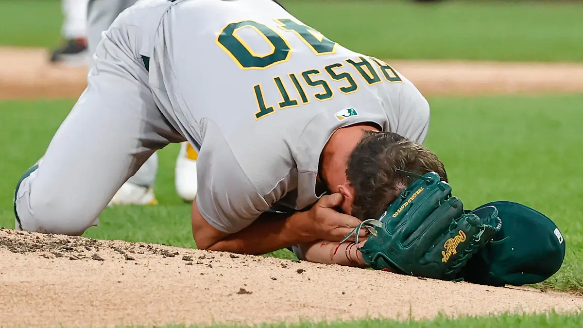Aug 17, 2021; Chicago, Illinois, USA; (EDITORS NOTE: graphic content) Oakland Athletics starting pitcher Chris Bassitt (40) covers his face after being hit by a ball hit by Chicago White Sox left fielder Brian Goodwin during the second inning at Guaranteed Rate Field. Mandatory Credit: Kamil Krzaczynski-USA TODAY Sports