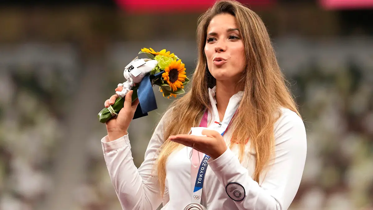 Silver medalist Maria Andrejczyk, of Poland, poses on the podium during the medal ceremony for the women's javelin throw at the 2020 Summer Olympics, Saturday, Aug. 7, 2021, in Tokyo. (AP Photo/Martin Meissner)