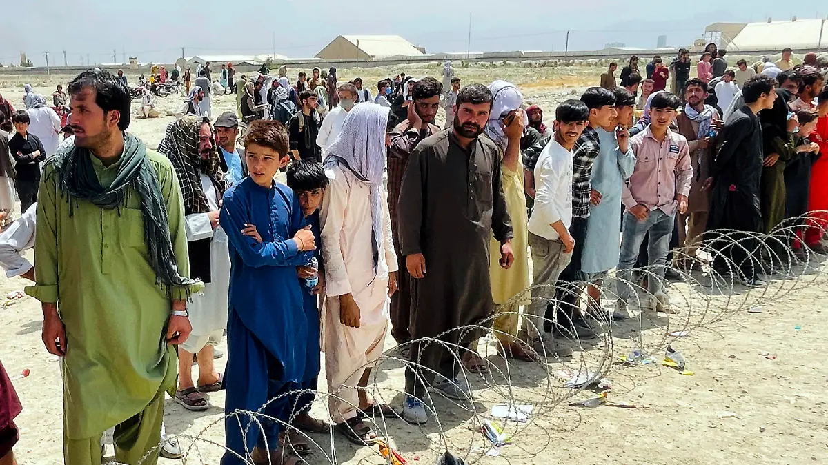 Hundreds of people gather outside the international airport in Kabul, Afghanistan, Tuesday, Aug. 17, 2021. The Taliban declared an “amnesty” across Afghanistan and urged women to join their government Tuesday, seeking to convince a wary population that they have changed a day after deadly chaos gripped the main airport as desperate crowds tried to flee the country. (AP Photo)