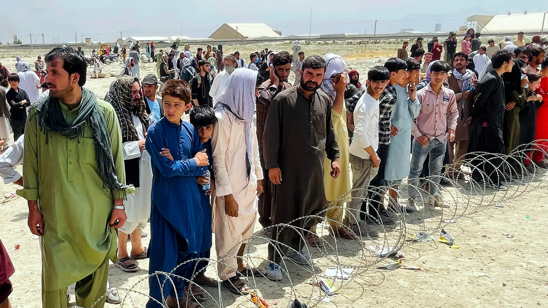 Hundreds of people gather outside the international airport in Kabul, Afghanistan, Tuesday, Aug. 17, 2021. The Taliban declared an “amnesty” across Afghanistan and urged women to join their government Tuesday, seeking to convince a wary population that they have changed a day after deadly chaos gripped the main airport as desperate crowds tried to flee the country. (AP Photo)