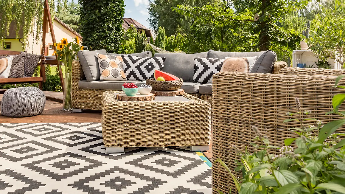 New design villa patio with comfortable rattan furniture and pattern carpet