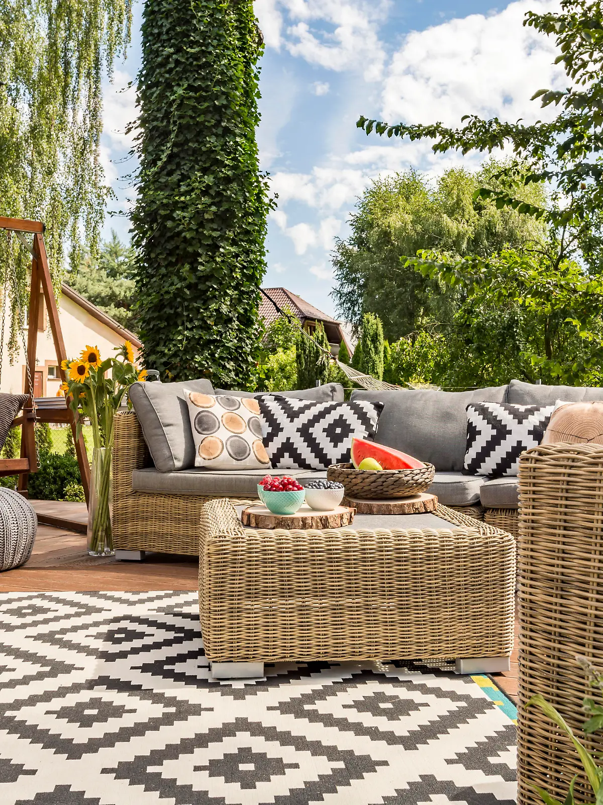 New design villa patio with comfortable rattan furniture and pattern carpet