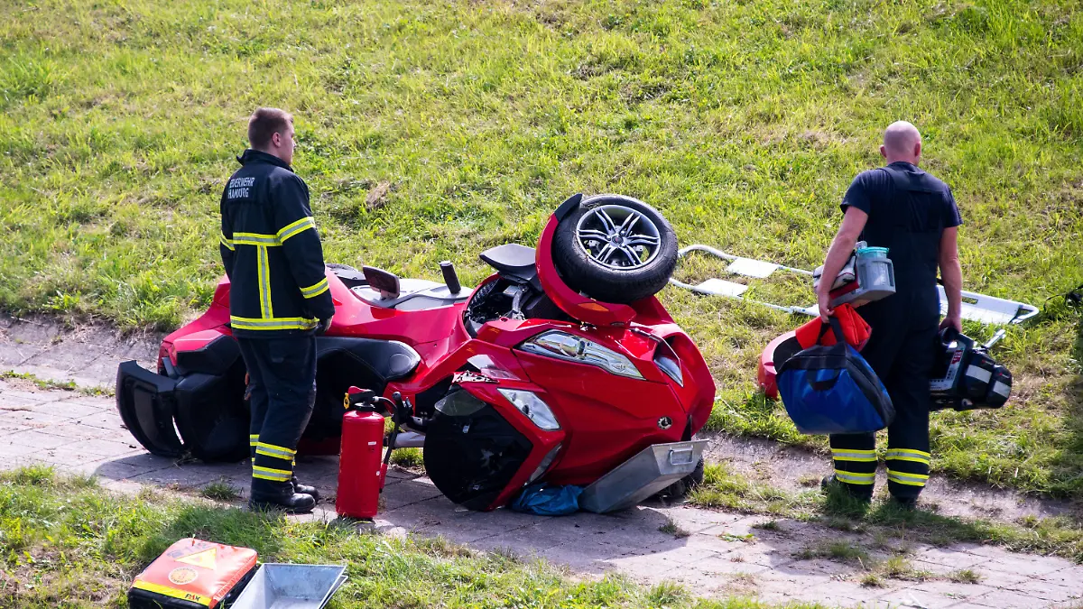 24.08.2023, Hamburg: Einsatzkräfte stehen im Stadtteil Altengamme nach einem Verkehrsunfall an einem Quad. Beim Zusammenstoß des Quads mit zwei Fußgängern sind ein Junge ums Leben gekommen und drei weitere Personen schwer verletzt worden. Foto: Daniel Bockwoldt/dpa +++ dpa-Bildfunk +++