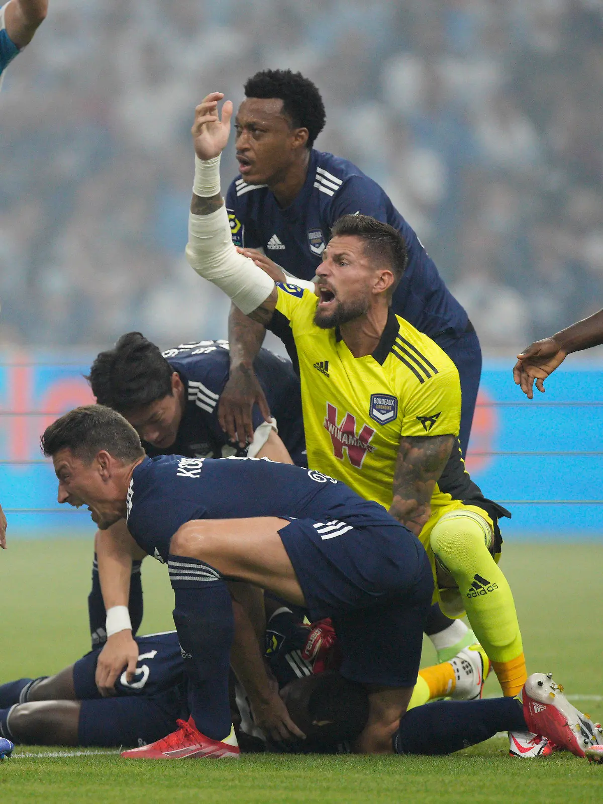 Bordeaux's Samuel Kalu lays on the pitch as players call the medic during the French League One soccer match between Marseille and Bordeaux at the Velodrome stadium in Marseille, southern France, Sunday, Aug. 15, 2021. (AP Photo/Daniel Cole)