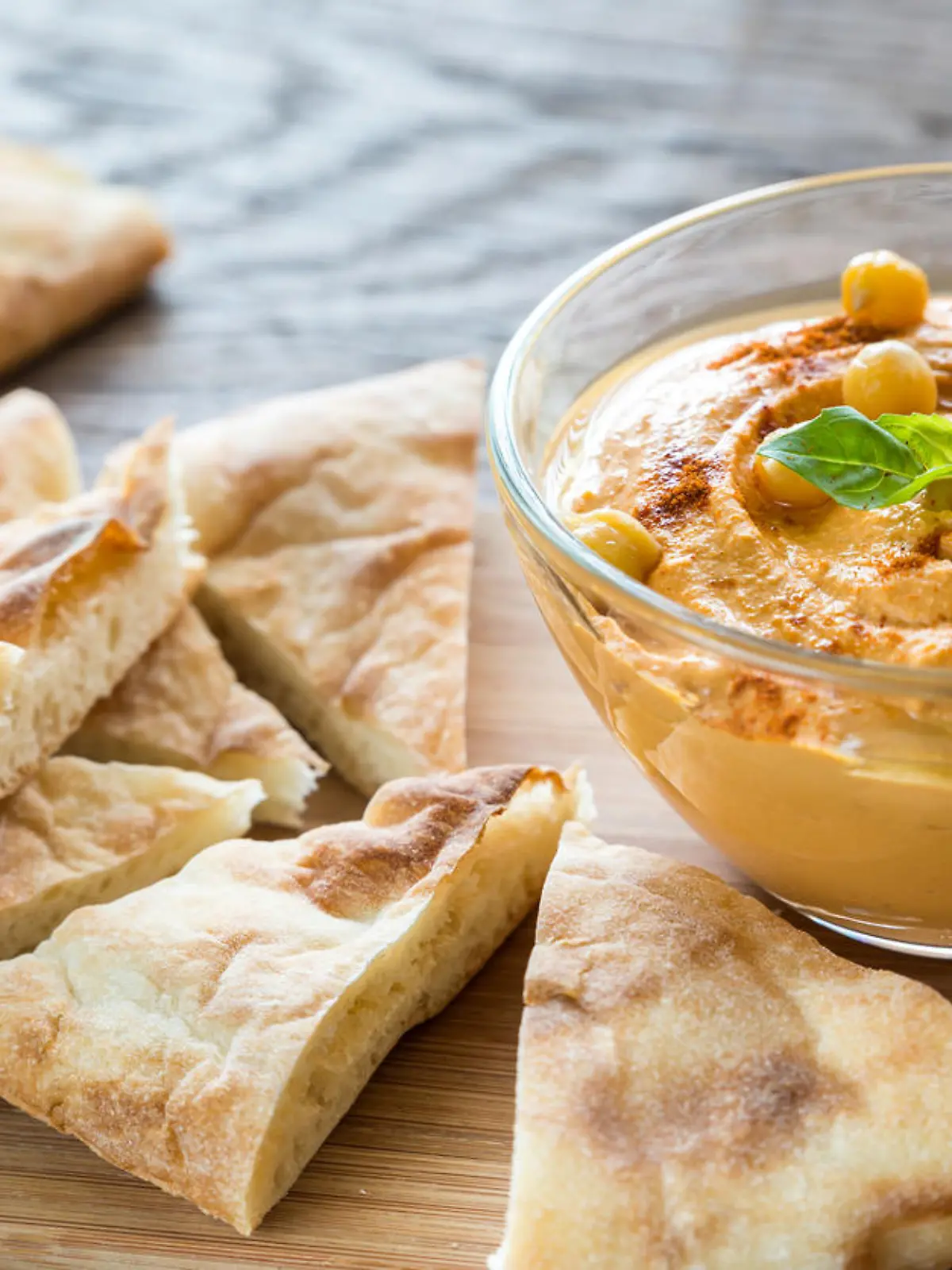 Bowl of hummus with pita slices