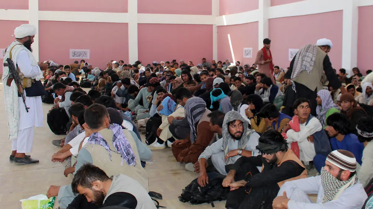 13.08.2021, Afghanistan, Ghazni: Taliban-Kämpfer bewachen afghanische Sicherheitskräfte die sich ergeben hatten in der Stadt Ghazni südwestlich von Kabul, Afghanistan. Die Taliban haben am Freitag ihre Offensive im Süden des Landes abgeschlossen und in einer Blitzoffensive vier weitere Provinzhauptstädte eingenommen, die Kabul allmählich einkreisen, nur wenige Wochen bevor die USA ihren zwei Jahrzehnte währenden Krieg offiziell beenden wollen. UN-Generalsekretär António Guterres hat die  militant-islamistischen Taliban zur sofortigen Einstellung ihres gewaltsamen Vormarsches in Afghanistan aufgerufen. «Die Macht durch militärische Gewalt an sich zu reißen ist ein zum Scheitern verurteiltes Vorgehen», sagte Guterres. Foto: Gulabuddin Amiri/AP/dpa +++ dpa-Bildfunk +++
