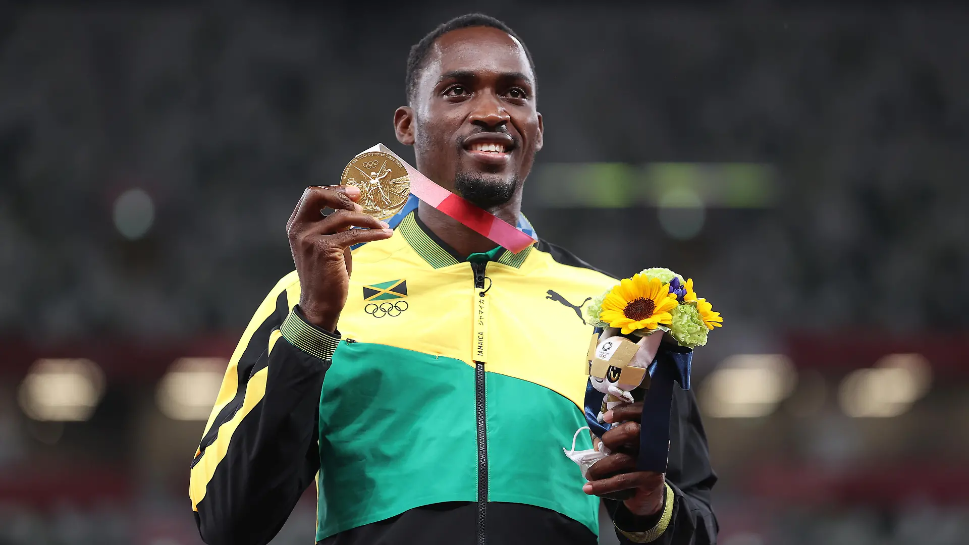 TOKYO, JAPAN - AUGUST 05: Gold medalist Hansle Parchment of Team Jamaica holds up his medal on the podium during the medal ceremony for the Men’s 110m Hurdles on day thirteen of the Tokyo 2020 Olympic Games at Olympic Stadium on August 05, 2021 in Tokyo, Japan. (Photo by Michael Steele/Getty Images)