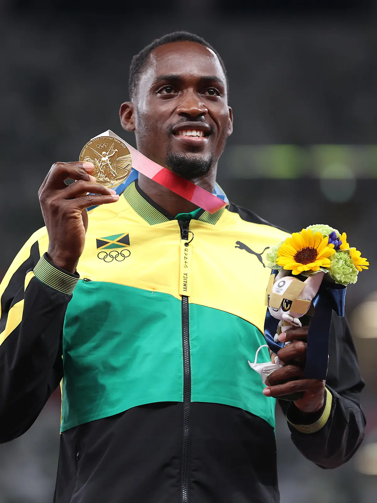 TOKYO, JAPAN - AUGUST 05: Gold medalist Hansle Parchment of Team Jamaica holds up his medal on the podium during the medal ceremony for the Men’s 110m Hurdles on day thirteen of the Tokyo 2020 Olympic Games at Olympic Stadium on August 05, 2021 in Tokyo, Japan. (Photo by Michael Steele/Getty Images)