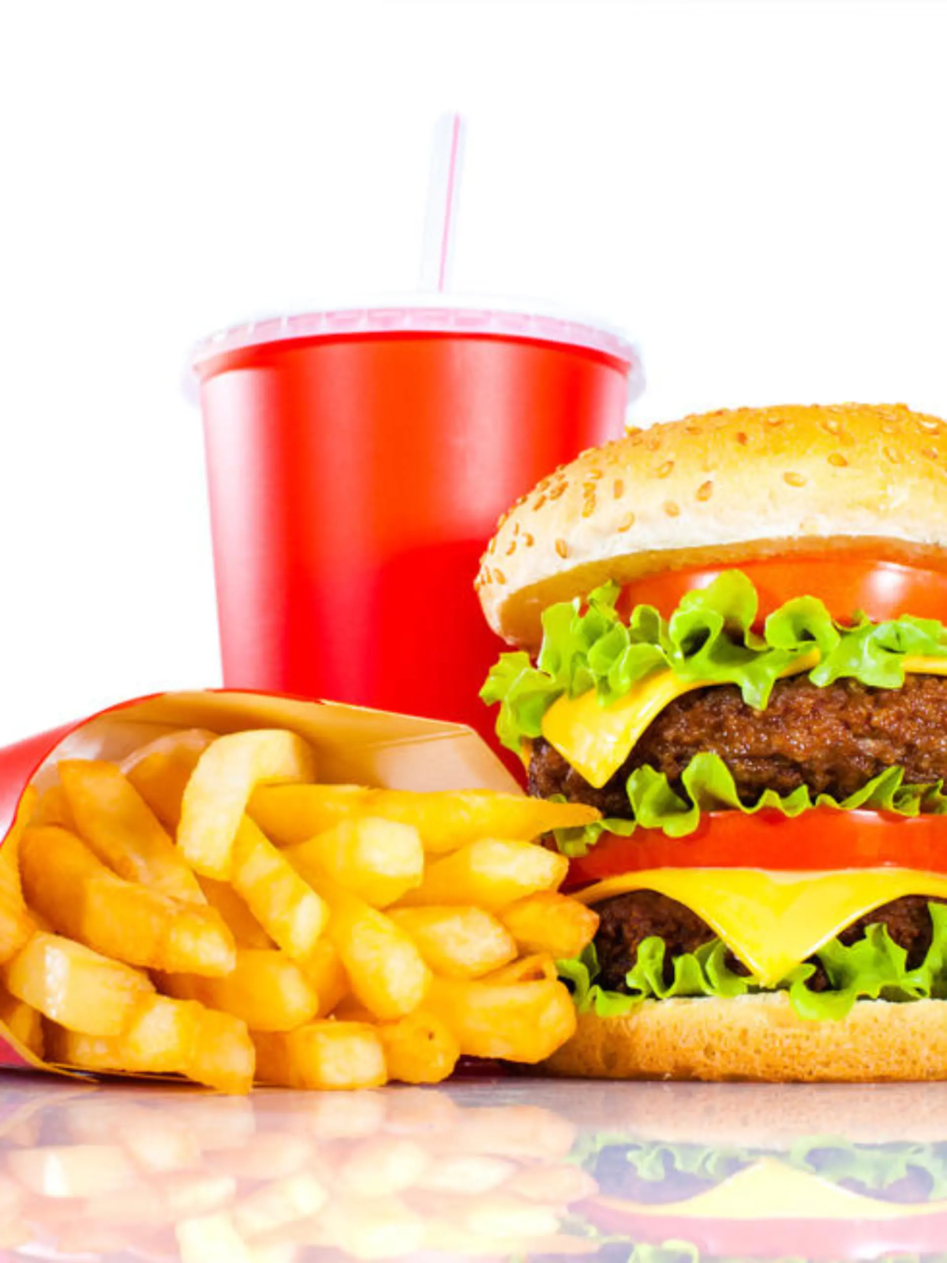 Tasty hamburger and french fries on a white background
