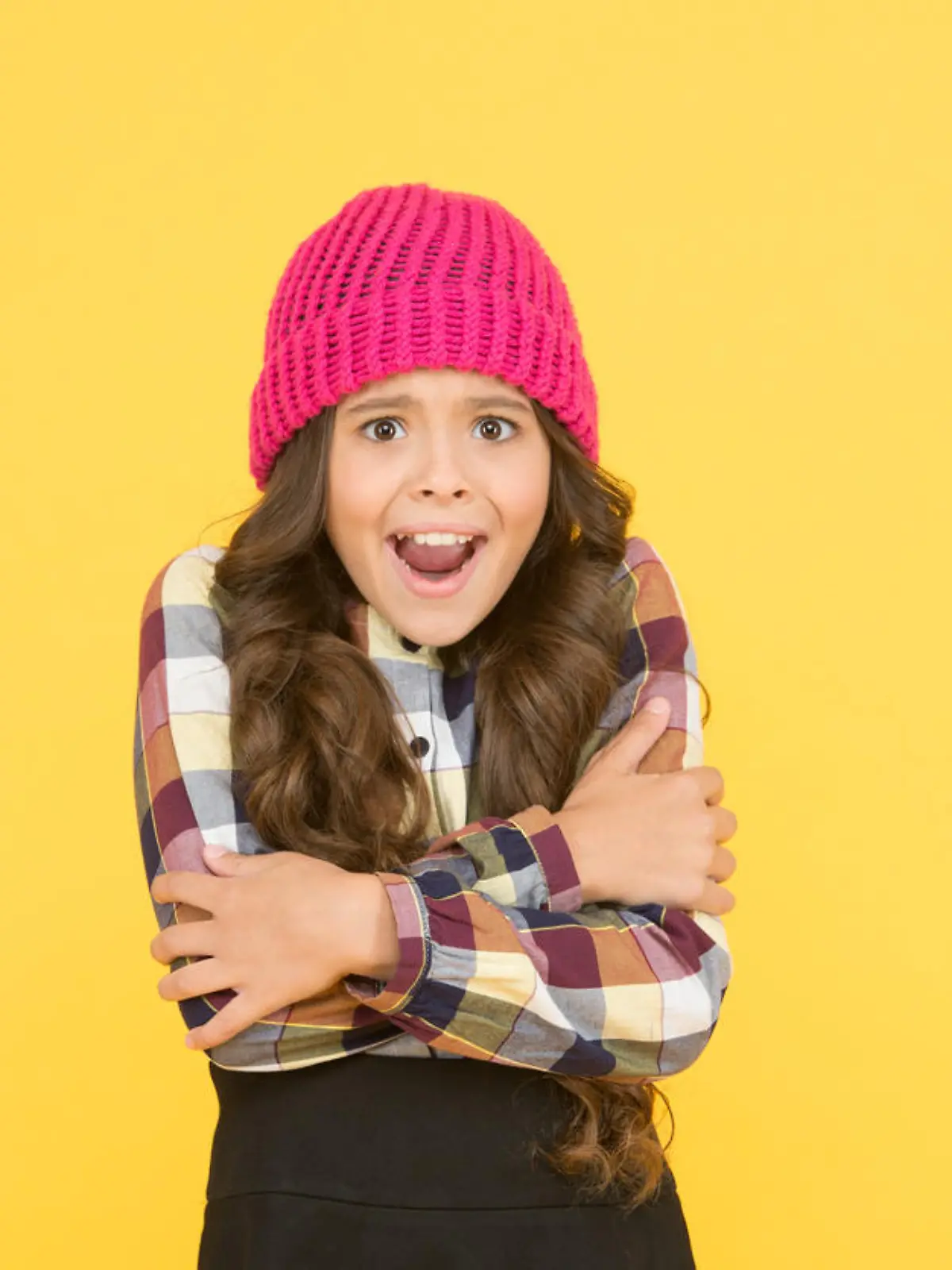 She is cold. Unhappy little child feel cold yellow background. Small girl shiver in cold weather headwear. Crispy autumn or winter season. Chilly and cold. Coldness.