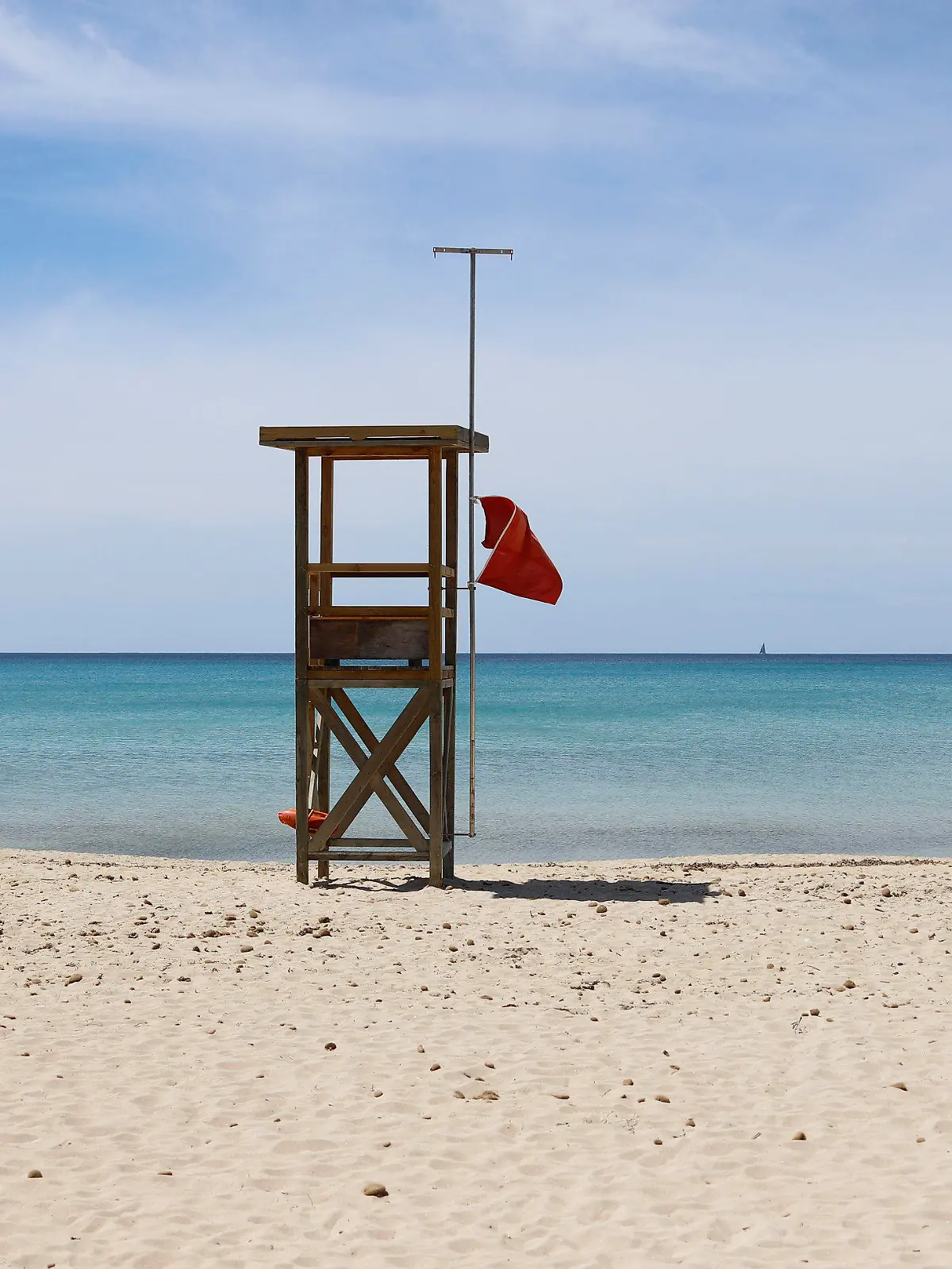 07.05.2020, Spanien, Palma: Eine rote Flagge weht am Strand von Arenal, um das Schwimmen zu verbieten. Die Abwesenheit von Touristen ist an den Stränden Mallorcas spürbar. «Das Wasser ist derzeit spektakulär transparent», sagt der Biologe Txema Brotons. (zu dpa "Mallorca ohne Urlauber - ein Segen für die Umwelt?") Foto: Clara Margais/dpa +++ dpa-Bildfunk +++
