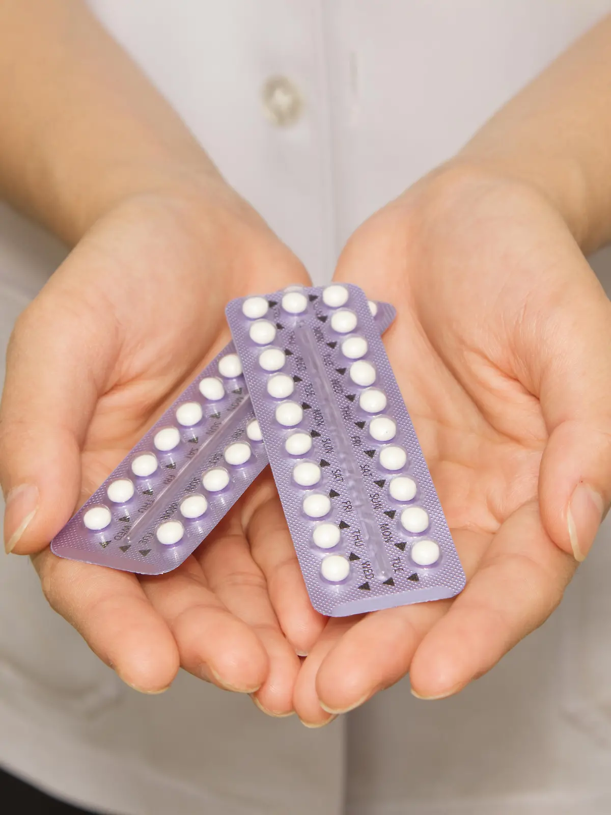 doctor's hand  holding the birth control pills
