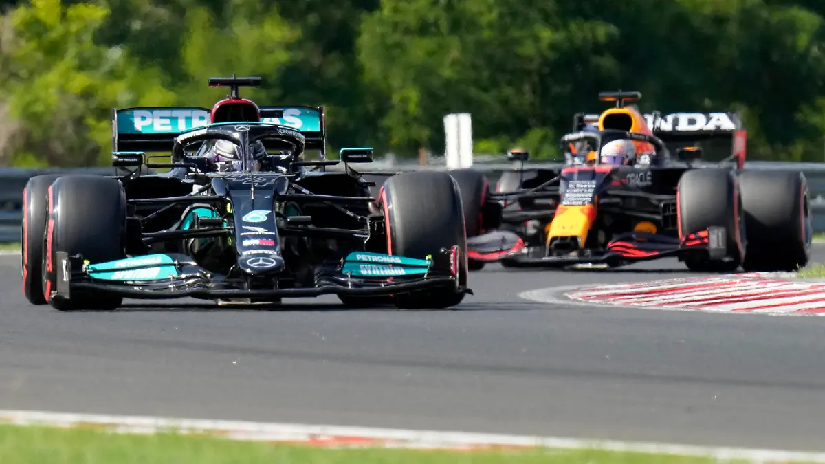 Mercedes driver Lewis Hamilton of Britain steers his car followed by Red Bull driver Max Verstappen of the Netherlands during the qualifying session for the Hungarian Formula One Grand Prix at the Hungaroring racetrack in Mogyorod, Hungary, Saturday, July 31, 2021. The Hungarian Formula One Grand Prix will be held on Sunday. (AP Photo/Darko Bandic)