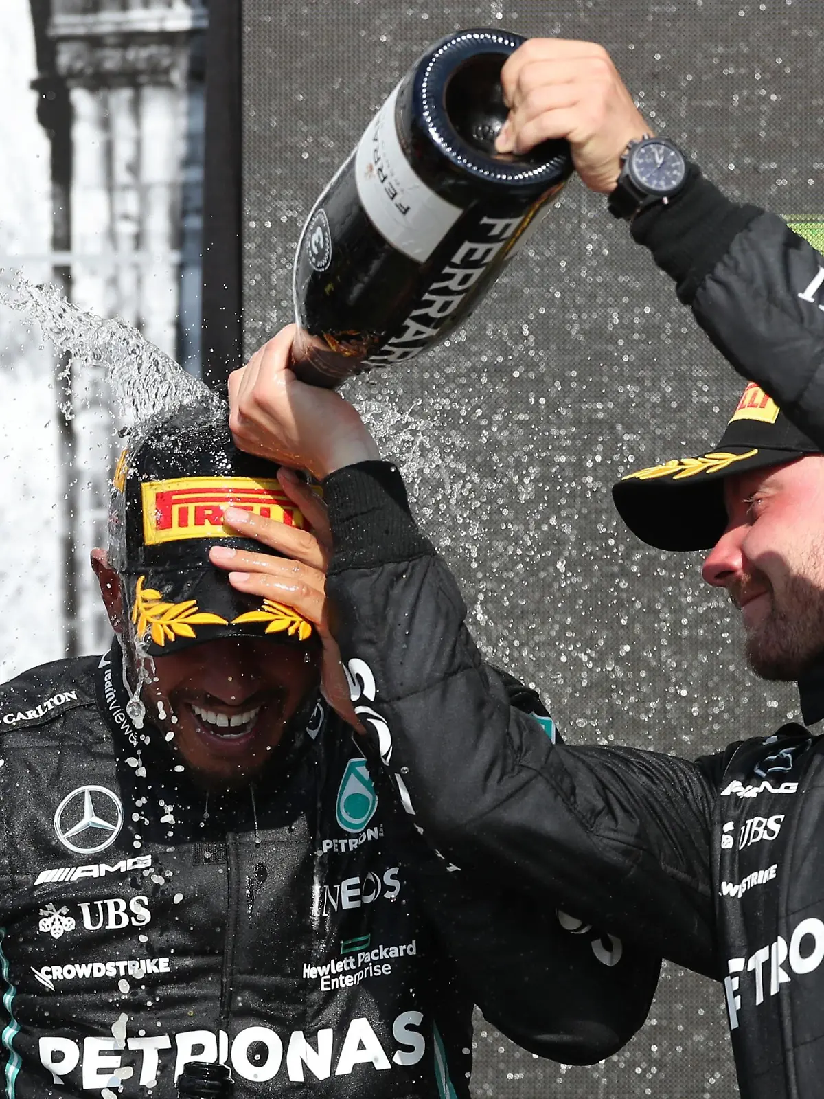 Formula One F1 - British Grand Prix - Silverstone Circuit, Silverstone, Britain - July 18, 2021 Mercedes' Lewis Hamilton celebrates on the podium after winning the race with third place Mercedes' Valtteri Bottas REUTERS/Peter Cziborra