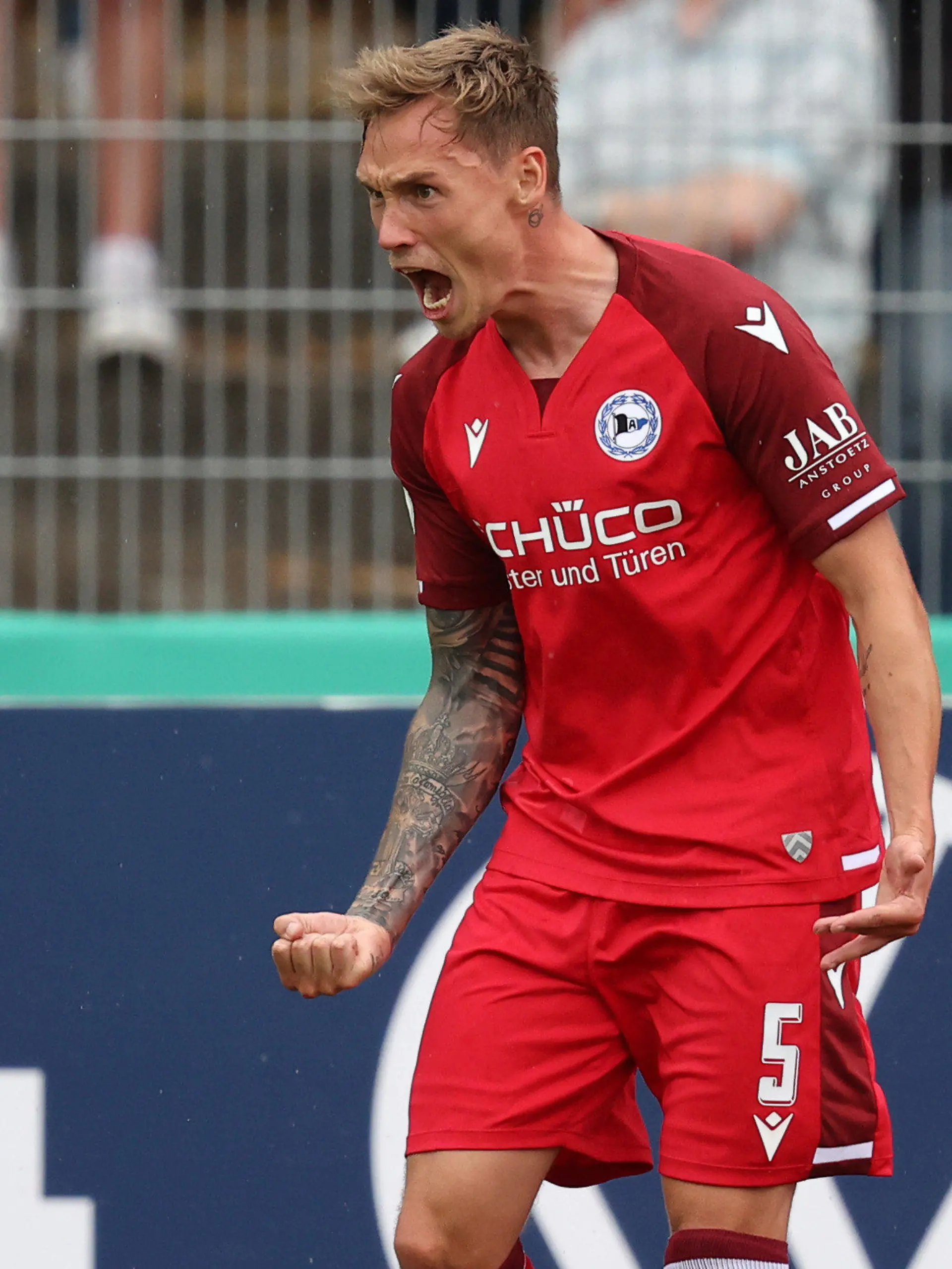 07.08.2021, Bayern, Bayreuth: Fußball: DFB-Pokal, SpVgg Bayreuth - Arminia Bielefeld, 1. Runde im Hans-Walter-Wild-Stadion. Jacob Laursen von Arminia Bielefeld jubelt über seinen Treffer zum 0:1. (Wichtiger Hinweis: Der DFB untersagt die Verwendung von Sequenzbildern im Internet und in Online-Medien während des Spiels (einschließlich Halbzeit). Sperrfrist! Der DFB erlaubt die Publikation und Weiterverwertung der Bilder auf mobilfunkfähigen Endgeräten (insbesondere MMS) und über DVB-H und DMB erst nach Spielende.) Foto: Daniel Karmann/dpa - WICHTIGER HINWEIS: Gemäß den Vorgaben der DFL Deutsche Fußball Liga bzw. des DFB Deutscher Fußball-Bund ist es untersagt, in dem Stadion und/oder vom Spiel angefertigte Fotoaufnahmen in Form von Sequenzbildern und/oder videoähnlichen Fotostrecken zu verwerten bzw. verwerten zu lassen. +++ dpa-Bildfunk +++