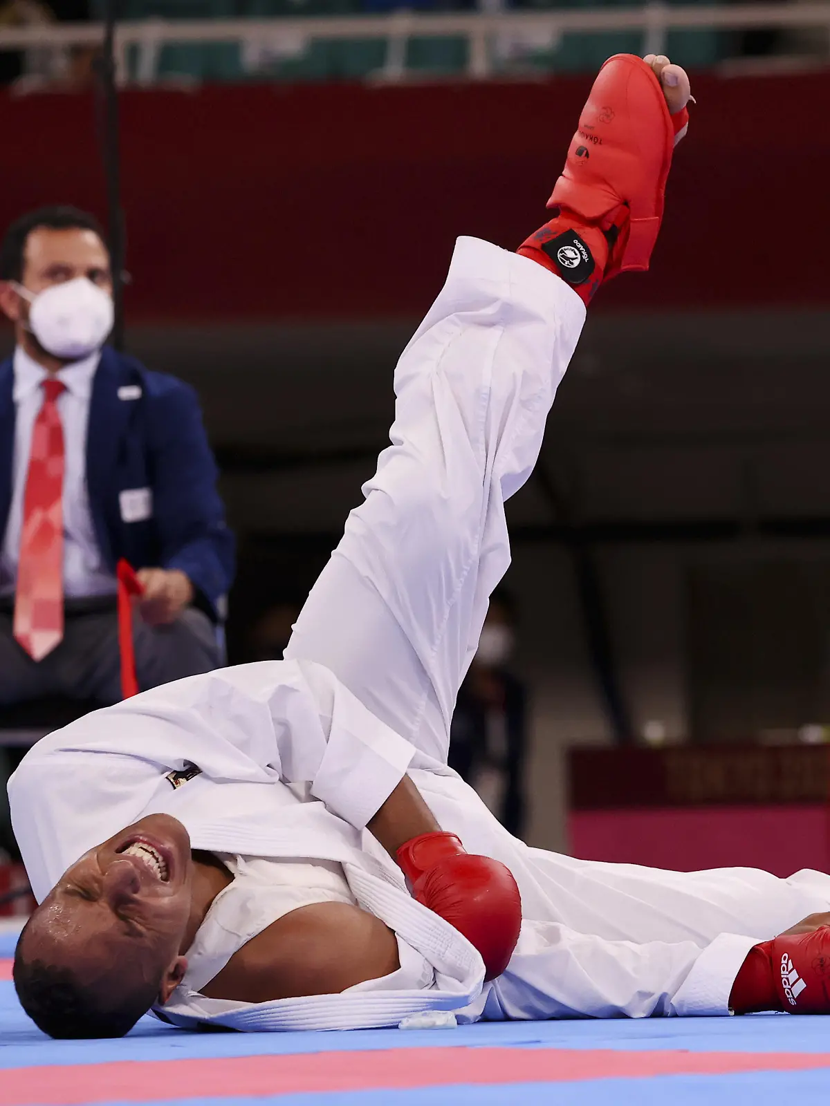 Tokyo 2020 Olympics - Karate - Men's +75kg Kumite - Pool A - Nippon Budokan, Tokyo, Japan - August 7, 2021. Jonathan Horne of Germany reacts on the mat as he sustains an injury during his match against Gogita Arkania of Georgia. REUTERS/Ivan Alvarado