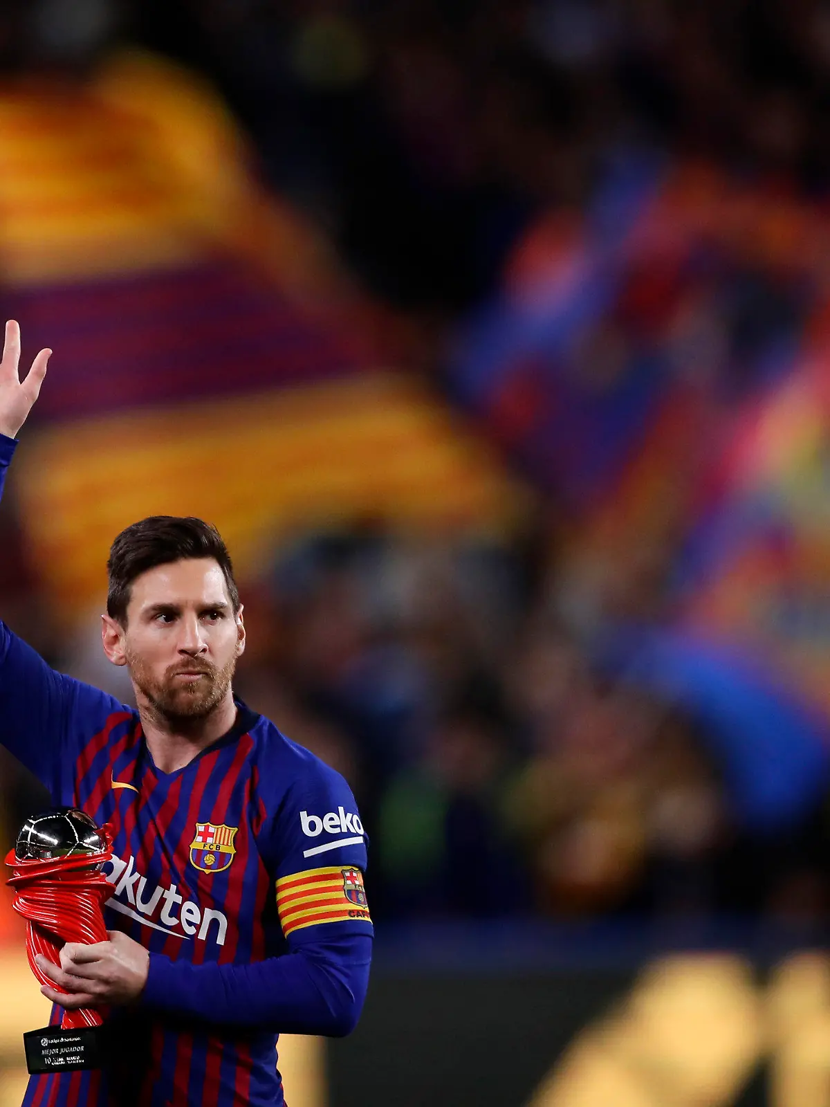 FILE - In this Saturday, April 6, 2019 file photo, Barcelona forward Lionel Messi waves at the crowd as he holds the trophy of the best Spanish La Liga player prior to a soccer match between FC Barcelona and Atletico Madrid at the Camp Nou stadium in Barcelona, Spain. Barcelona says Lionel Messi will not stay with the club, it was reported on Aug. 5, 2021 in a statement that a deal between the club and the player had been reached but financial “obstacles” made it impossible for the player to remain with the club.  (AP Photo/Manu Fernandez, File)
