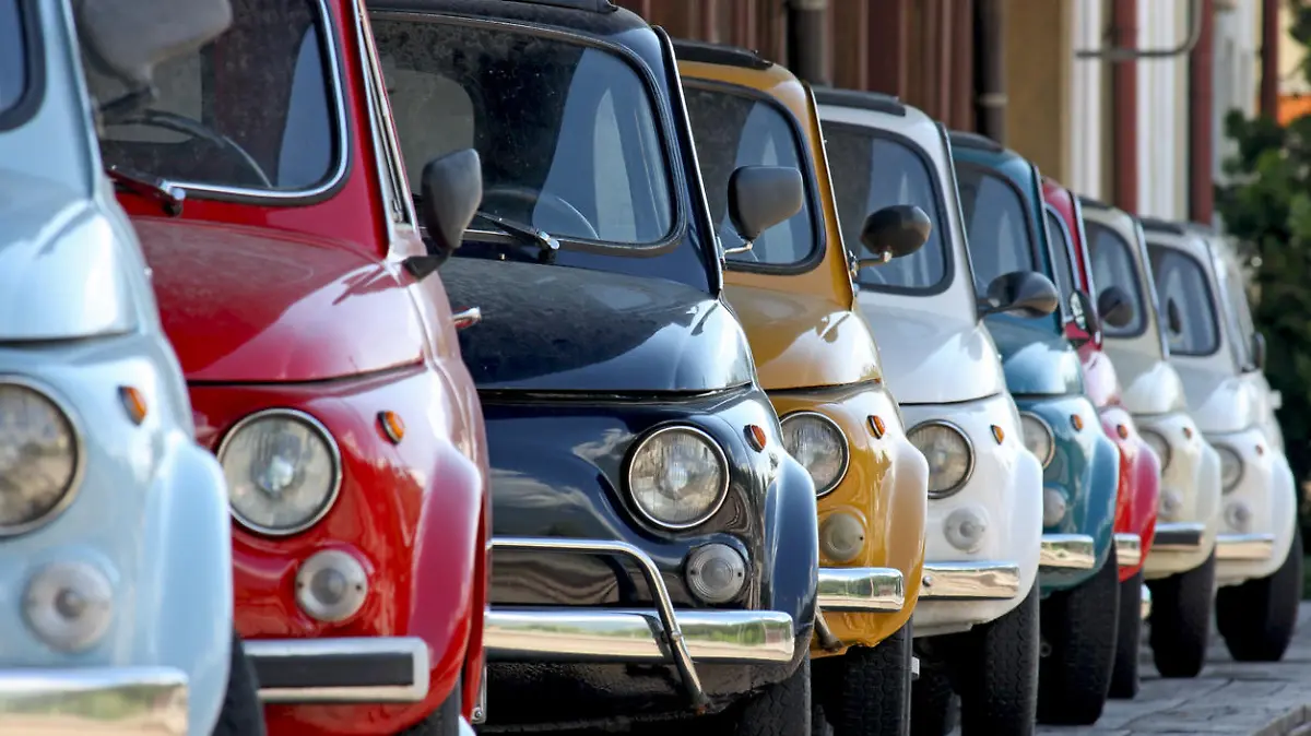 Row of coloured vintage italian cars. They are one of the most popular compact Italian cars produced between '60 and '70.